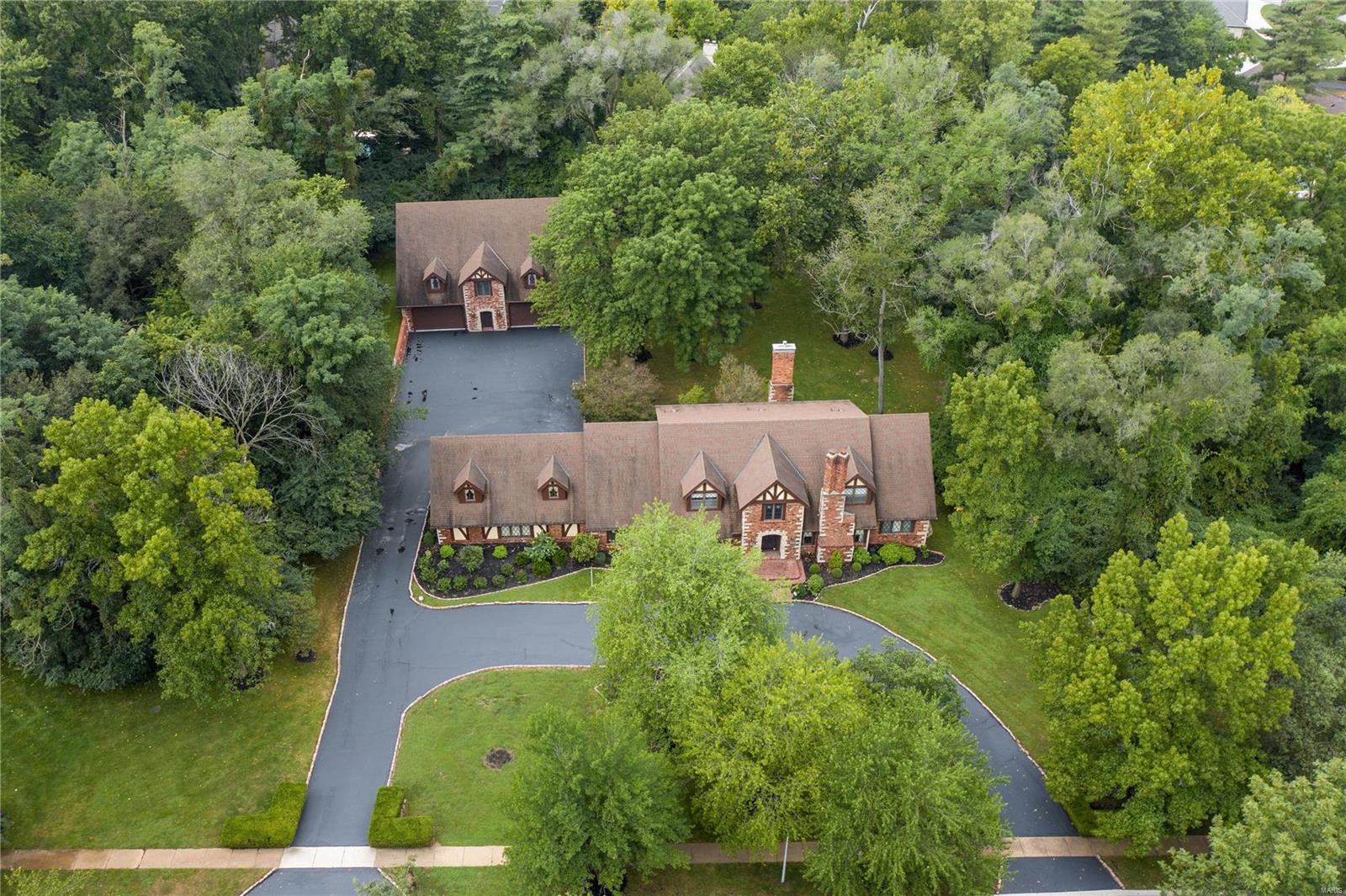 Nestled on a tree-lined street and just a stone’s throw from a serene pond, this 4+ bed, 6 bath home sits on over 1.5 secluded, expertly landscaped acres with a 2500 sq foot ‘carriage house/12 car garage’, built with the same high end quality materials as the main house.  Find stained glass windows, herringbone hardwood flooring, oversized brick detailing, custom millwork, main floor master suite, 3 bedrm suites and 2 private offices in the main house.  The custom kitchen and breakfast rm enjoy a view of the very private backyard through the sun rm.  A newer media/theatre rm in the low lev, formal liv and din rm, gorgeous family rm with beamed ceilings and wet bar, main flr laundry and 3 car garage complete the main house.  No other property offers a ‘carriage/garage house’ quite like this one.  The possibilities are endless.  Large enough to house a dozen cars, a large rec/workout area, a pool house, guest quarters etc…  You will not believe all of the space!!!