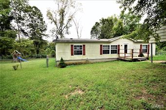 OWNER MAY CONSIDER LEASE TO OWN! This 3 bed, 2 bath home truly is a great find! Enter the front door to a spacious family room w/a large window overlooking the front yard. The kitchen is updated w/amazing cabinetry & offers a TON of counter space. The eat-in kitchen, w/a built in cabinet perfect for an upright freezer, has a sliding glass door, which leads to a large back deck overlooking the back yard. The mud room & laundry room off the kitchen also has a door leading to the back deck. The back yard is fenced in & has a utility shed w/electric. Off the family room is a Master Suite, w/walk-in closet & bath with a shower and soaking tub. To the other side of the home are 2 more bedrooms, each w/great closets, & a room w/a set of built in bookshelves. In the front is a 2 car carport & a parking pad. Home is being sold as-is. Seller to do no repairs, all inspections are for Buyers informational purposes only. The play set & utility shed do stay w/the property.