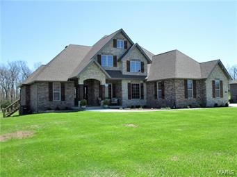 This is a MUST SEE Brand New all Brick & Stone Home in Castle Rock Estates w/Full Walkout Basement that sits on over  1 acre w/a very Private Setting. There is over 2200 sq. ft. on the Main Floor & 1850 sq. ft. Finished in the Basement w/ 400 sq. ft. of unfinished storage area & a Tornado shelter. This Beautiful home has 5 Bedroom, 5 baths, 2 Laundry Rooms, 3 living areas and a 3 car garage. Home has a Split Bedroom, Open Floor Plan w/ Mostly Hardwood Flooring. Covered Deck w/ an Uncovered area for grilling.  The Custom Kitchen has a Walk in Pantry, Double Ovens, Gas Cook Top, Breakfast Bar & a Large Center Island.  The Living area has Floor to Ceiling Cedar Columns accented w/Stone & Cedar Beams in the Vaulted Living Room Ceiling, Anchored by a Custom Brick & Stone Fireplace. The Master Bathroom offers a large Custom Tiled Walk in Shower, & a Jacuzzi Tub. In the Lower Level you will find 3 Bedrooms, 1 full & 1 1/2 baths, Recreational area, Kitchenette, Living Room, laundry room. Additional Rooms: Mud Room