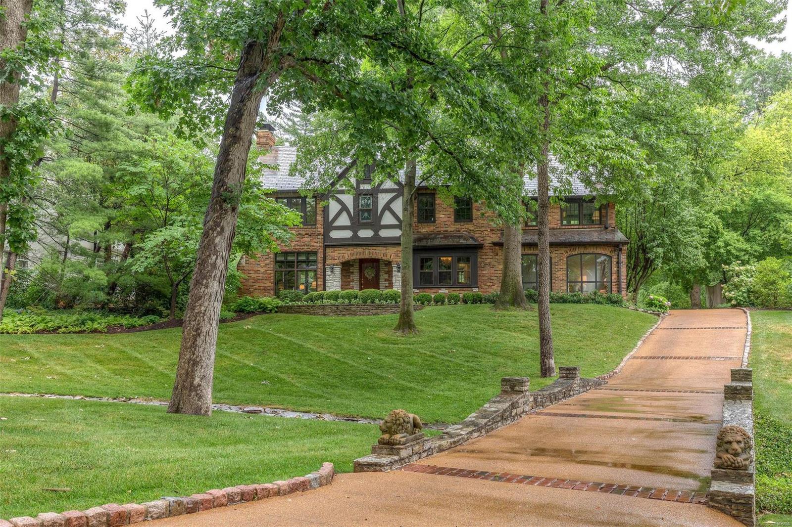 Classic Tudor Architecture in Premier Ladue neighborhood blends original workmanship with modern & stylish updates.  The flag stone walkway leads to handsome arched brick & stone covered entrance. Superb structure & abundance of windows gives warm welcome & fills every room with light enhancing high ceilings, moldings & built-ins. Beautiful Terrazzo floor & stone fireplace in living room; generous sized dining room with window seat; family room with floor to ceiling windows overlooks picturesque property. Updated kitchen embodies chic style with marble counters. Upstairs, 4 bedrooms, 2 baths. The master bedroom, a private oasis bathed in light on 3 sides, has an adjacent 15x11 sitting room. Lower level family room is cozy w/paneling, wet bar & new gas ventless fireplace. The heated pool & park-like setting with mature trees & exquisite landscaping of plantings & perennials along curved walkways, offers privacy & great space for family & special guests. You can’t miss seeing this! Hurry