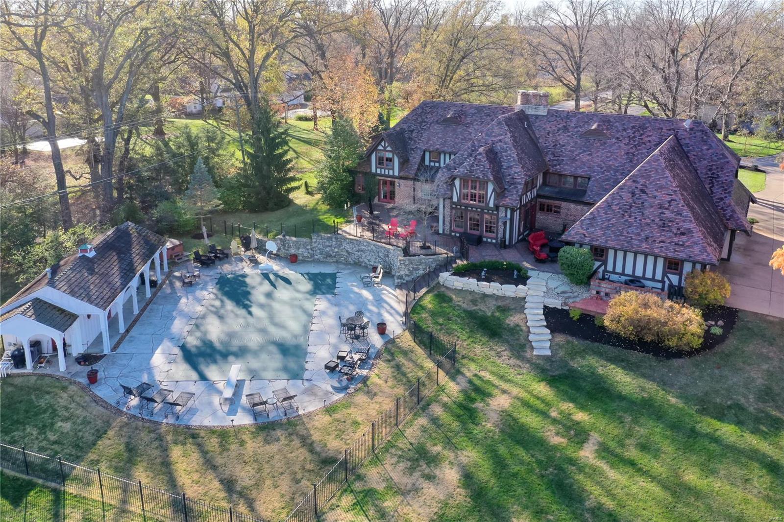 Fully improved Executive home on a premier street in the heart of Frontenac. Approx. 7,000 square feet of living area with main level primary suite featuring renovated bathroom and room-sized organized closet. Reclaimed pine flooring with radiant heat, and spectacular vaulted great room with antique pine ceiling. Large level 1.5 acre lot with pebble sheen pool and fully outfitted pool house. Ideally suited for outdoor entertaining with expansive patios. Updated kitchen features Viking and SubZero appliances, and custom glass front cabinetry. Four bedrooms + exercise room and home theater/Golf practice studio on 2nd level, with it's own separate stairwell from the exterior for the ideal in-law or au-pair quarters. Finished lower level includes billiard and family rooms as well as custom wine room. Four car garage parking with expansive circle drive. Clay tile roof, copper gutters, concrete and paver driveway. True one-of-a-kind retreat. Near highway access, shopping, and dining.
