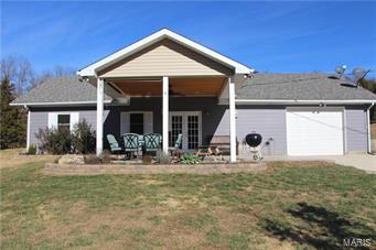 1200 Square ft 2 bedroom 2 bath home on secluded flat 5.21 +/- acres with a great mixture of field and woods. Home is last house on a dead end road. It's in Grandview school district. Backs up to 150+ acres of woods. Nice for horses, hunting. Lots of wildlife and privacy. Includes area dug for pond. 1 car oversized garage. Large covered stamped concrete pad , great for entertaining. Inside of home is completely remodeled, everything less than 8 years old. Newer carpet, newer roof, newer water softer, newer flooring throughout, newer windows, newer water heater, newer ceiling fans, large soaking/jet Whirlpool tub. This is a cute home that is perfect for the family that loves the outdoors.