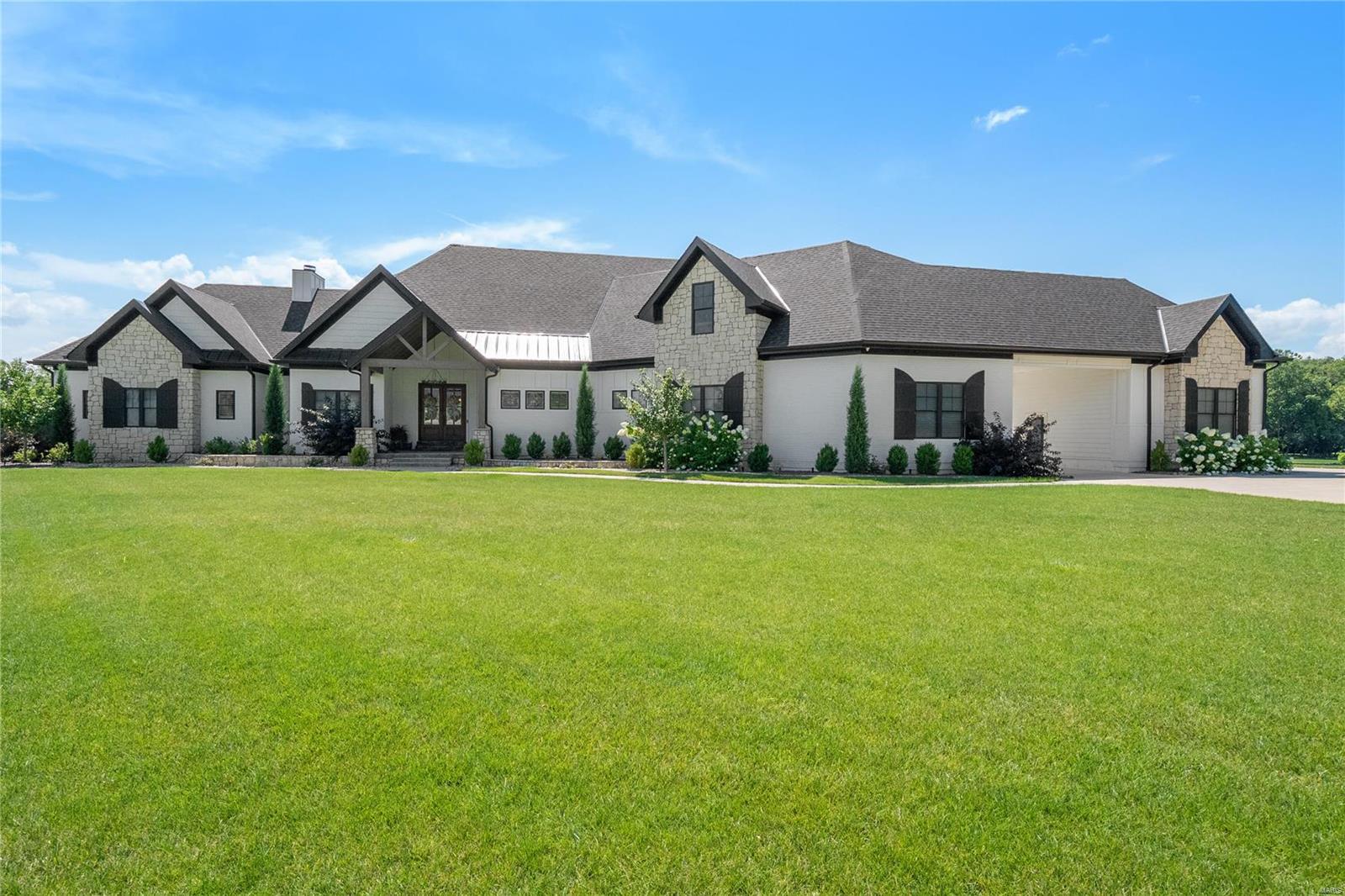 Stunning 1.5 story with all the bells and whistles. Located in the prestigious gated Stonecastle neighborhood, this amazing home sits on a 4.2 acre tree-lined lake lot! The spacious open floorplan has 10' ceilings, 9' doors, 7" oiled white oak floors, great room with stone fireplace w/gas logs, fabulous kitchen with furniture-grade cabinets, 10' island, 48" Thermador Range, Butlers Pantry w/ice maker,  and spacious dining area w deck access! The owners suite has an electric fireplace, a huge custom closet, and incredible bath with his & her vanities & amazing walk-in shower. Additional main level features include an office with pocket doors, a family rm, a bedroom w/private bath, 2 guest powder rooms, laundry w/brick floor, and garage entry into drop zone with built-in cubbies! Upper level has a bedroom, a bedroom/loft, and a full bath. Lower level is finished w/huge rec/family rm, a bedroom & full bath. Incredible 2 yr old Pool Tron pool, large patio, upper level deck, screened deck++