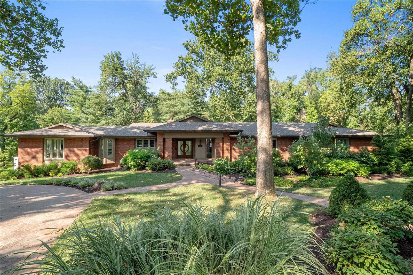 Nestled in serene surroundings on a private 1.8-acre landscaped lot, this Ralph Fournier-designed contemporary home boasts expansive glass windows and doors on all levels that open onto newly refinished Ipe decks, offering mesmerizing backyard views. The kitchen seamlessly connects to the family room, while a shared see-through marble fireplace adds elegance to the formal dining and living rooms. The primary suite is a haven with a spa-inspired bathroom featuring heated floors and a crafted walk-in closet. Main level comprises two bedrooms w custom walk in closets, full bathroom w/ steam shower and heated floors, convenient laundry, and powder room. The lower level features a spacious recreation area with 4K projector and 220” movie theater screen, exercise room, extra laundry, hallway bathroom, and bedroom suite w/ walk in custom closet. Custom Shutters, a whole-house generator, bonus room, Creston smart home automation, two EV chargers, and more add to this impeccable home.