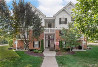 CAREFREE CONDO LIVING INCLUDING RESERVED CARPORT! Beautiful 2-Bedroom, 2-Bathroom condo in the heart of St. Peters. Easy access to major highways, dining, and entertainment in Fort Zumwalt school district. The open and neutral space welcomes you with fresh paint and laminate wood flooring throughout. Large bay window and corner gas fireplace help make this space cozy and quaint. The kitchen boasts ample oak cabinetry and abundant countertop space with upgraded countertops, sink, and pull-down faucet. Curl up with a book and relax on the private covered deck. Master Suite has large walk in closet, gorgeous granite sink, walk-in shower, and linen closet. This split-bedroom floor plan offers privacy and a full bathroom for guests. Maintenance-free community with beautiful landscaping, pool, park and more. Unit comes with 1 reserved covered parking space.  New water heater (2015). Location: End Unit