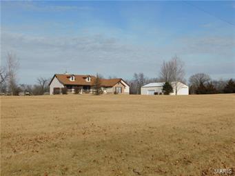 Looking for a nice home on acreage with an outbuilding? Look no further! This well cared for ranch style home sits just north of Troy on 7.86 usable acres. 1700 sq. ft main floor has 3 bedrooms, 2 ½ baths, vaulted great room with woodburning fireplace, large kitchen (fridge incl) w/ breakfast bar, a dining room & main floor laundry. French doors open to the large master suite where you’ll find a walk-in closet, double sinks, jetted tub and more French doors onto back deck. Upgrades to this home include 6 panel doors (most are 36” wide for wheelchair accessibility), attic van, central vacuum. gas and electric dryer hookups, architectural shingles, walk-out basement & more. The 2 ½ car attached garage is insulated as is the 40x60 building with concrete floor. It is also plumbed for air on all 4 sides (compressor incl.) and has 220V. Extra tall door will allow for motor home access. Easy access off State Highway K with less than ½ mile of gravel. Some Accessible Features