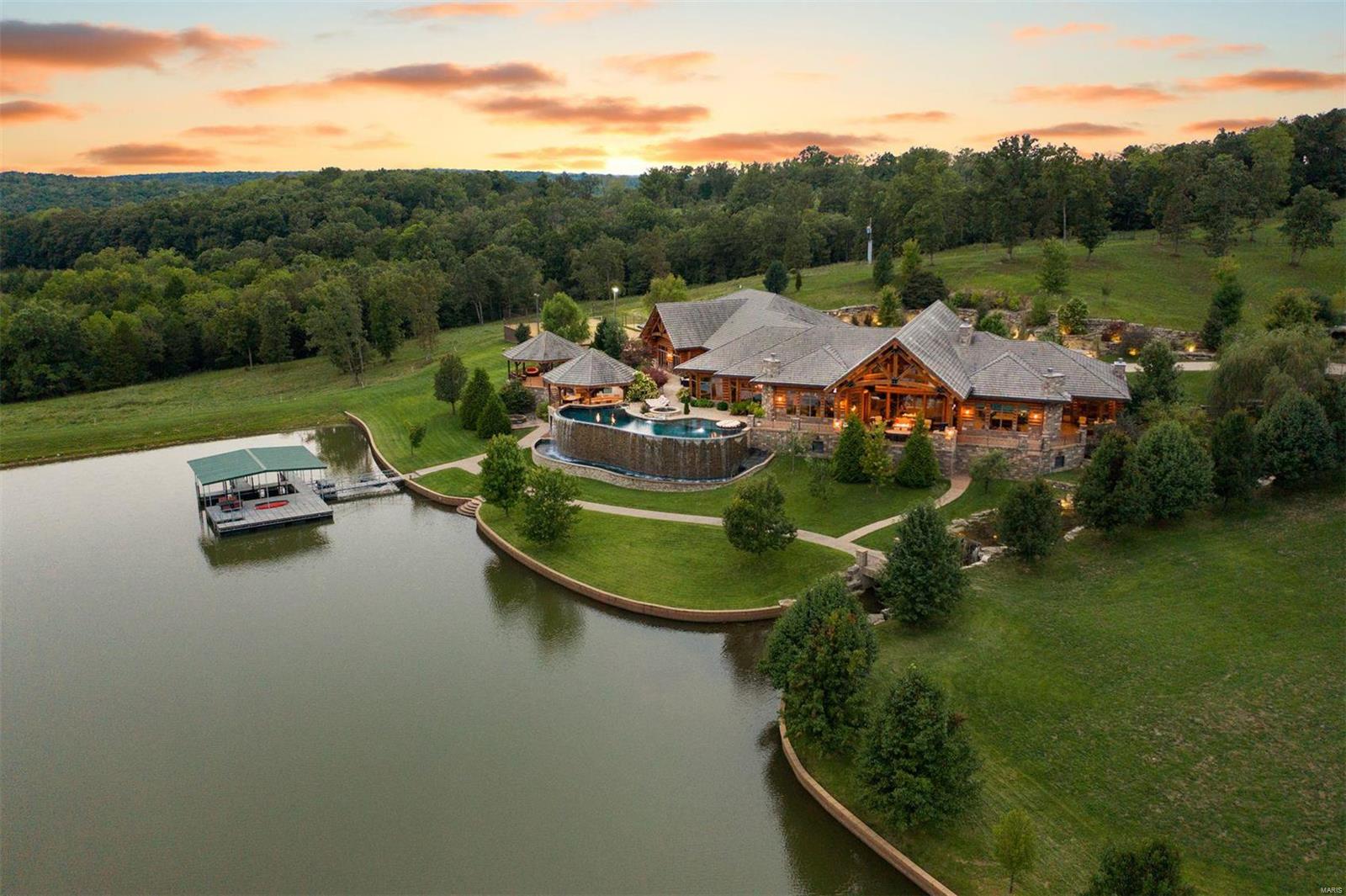 Horse Power Ranch is an elegant ranch estate that stretches across a mile of highway frontage and boasts over 800 acres of pristine property that has been meticulously sculpted into the landscape. The luxury 13,000 square foot log home is of exquisite quality, craftmanship and undoubtedly one of the finest properties in the country. Rich black walnut cabinets and crown molding throughout all milled from the trees on the property. Lakes, ponds, infinity pool plus a working cow calf and equine operation supported by an 11,000 square foot barn and stable.  An additional 10,000 square feet of additional buildings include a 2,400 square foot ranch manager residence and guest apartment. Only 10 minutes from a private airport and resort community of Lake of the Ozarks. Truly a private paradise in the heartland of America.
