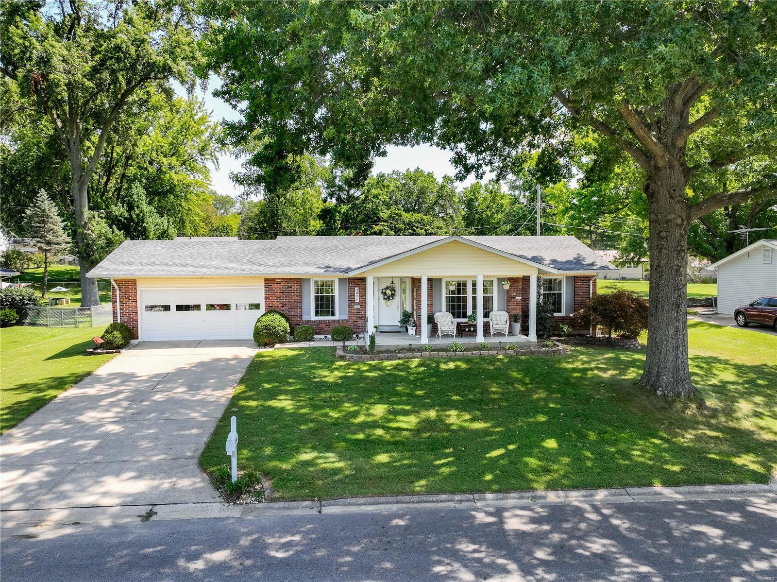 FABULOUS ranch home in wonderful neighborhood – TERRIFIC curb appeal, LOVELY cov. front porch; large 1/3rd-acre level lot on quiet street; A-rated Francis Howell Schools; beautiful hardwood floors, newer carpet throughout, 6 panel doors, neutral decor, multiple ceiling fan/lights, separate LRm & DRm; newer DRm chandelier/sconces; open floor plan from eat-in kitchen - ample cabinets, newer SS fridge & DW, porcelain sink, newer faucet - into cozy family rm w/ white-washed brick gas fireplace, built-in shelves, slider to private rear patio, large yard w/ privacy row of shrubs; primary BRm suite w/ walk-in closet; spacious LL rec. rm w/ bar; large unfin. area w/ workbench, storage shelves, & rough-in for bath; oversized, fin. garage w/ convenient door to backyard; mntnce-free siding; roof only 5 years old; new AC capacitor (2023). EASY access to Hwy 364/94 & I-70; Home protection plan in place for Buyer’s added peace of mind. Schedule an appointment to tour today – you’ll be glad you did!