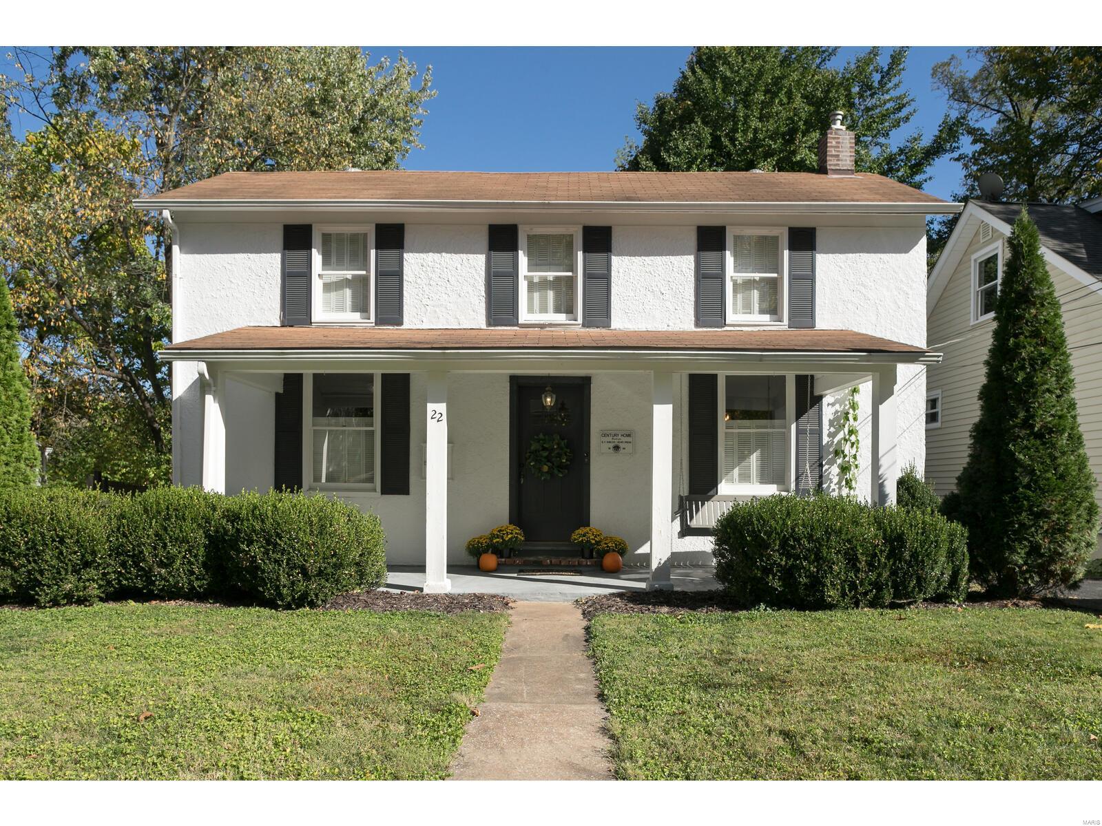 This charming Century Home is a great value with lots to offer in updates plus 2 full baths and large 2 car detached garage.  Fully fenced yard for pets and children.  Generous room sizes and ideal flow for comfortable living and entertaining.  Dining room has built in storage.  Pretty hardwood flooring main level and many windows have interior shutters.  Kitchen and baths are updated.  Main floor has full bathroom.  2 bedrooms on second floor, one has ensuite bathroom. Both bedrooms have wonderful closet space.  Lots of natural light.  12 x 10 deck off of kitchen for grilling and outside enjoyment.  Charming front porch with porch swing.  New flat roof over kitchen.  Updated electric panel. Laundry in basement, good storage, and basement walk up to exterior.  Passed Webster Groves occupancy inspection.  Proximity to Webster shopping and amenities is excellent. Larson Park nearby. Home warranty.