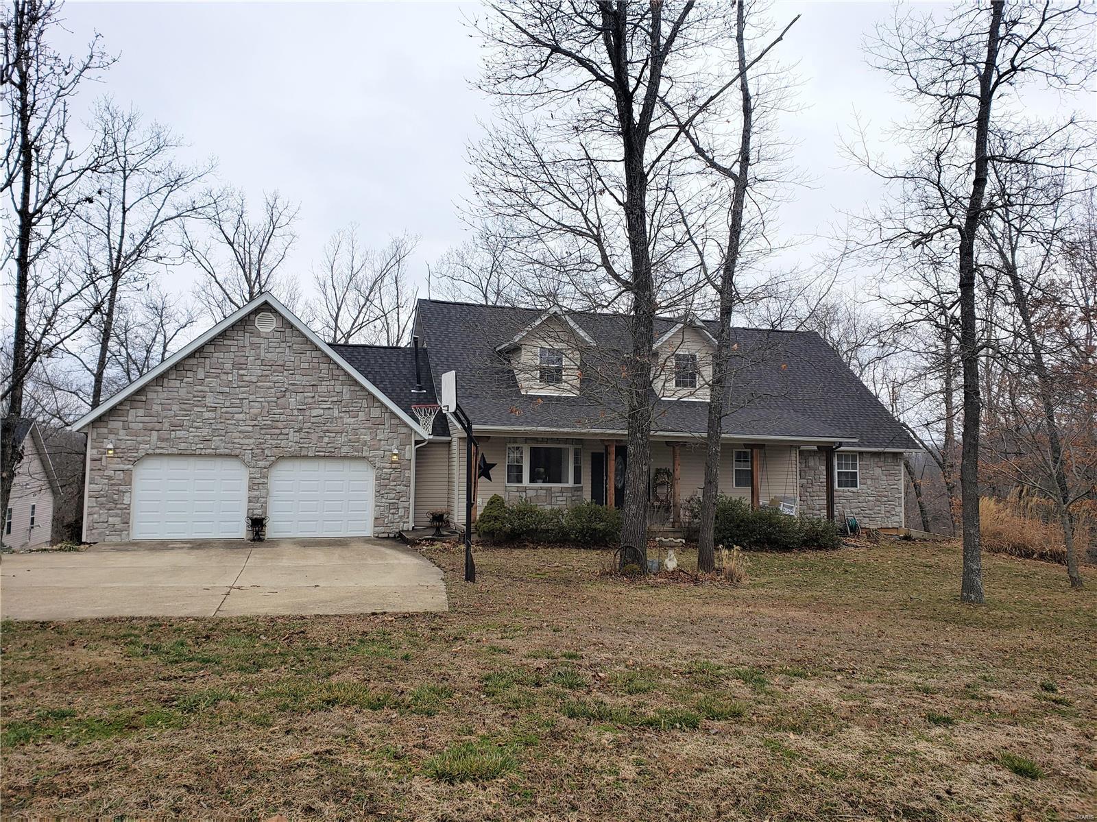 LOOK NO FURTHER!!  Gorgeous home with a huge detached garage/workshop on 5 acres in the Waynesville School District!!  Enter through the front door into a spacious living room with hardwood floors, ample seating, bay window, and a cozy fireplace. An over-sized dining room makes it great for gatherings and has a gorgeous view.  Kitchen features stainless appliances and quartz counter tops. Master bedroom has hardwood flooring, tons of natural light, and great views. Other 2 bedrooms on main level also have hardwood flooring and are over-sized.   Head up to the loft for a game of pool or use it for additional sitting area or an office. Basement features an huge great room with a bar seating area with cabinets and a wine/beer fridge.  2 additional, large bedrooms, a full bath, plus a storage room make this basement highly desirable. Step out onto the back deck and enjoy the views and a very nice hot tub.  Don't forget about the over sized detached garage/workshop that is heated too.