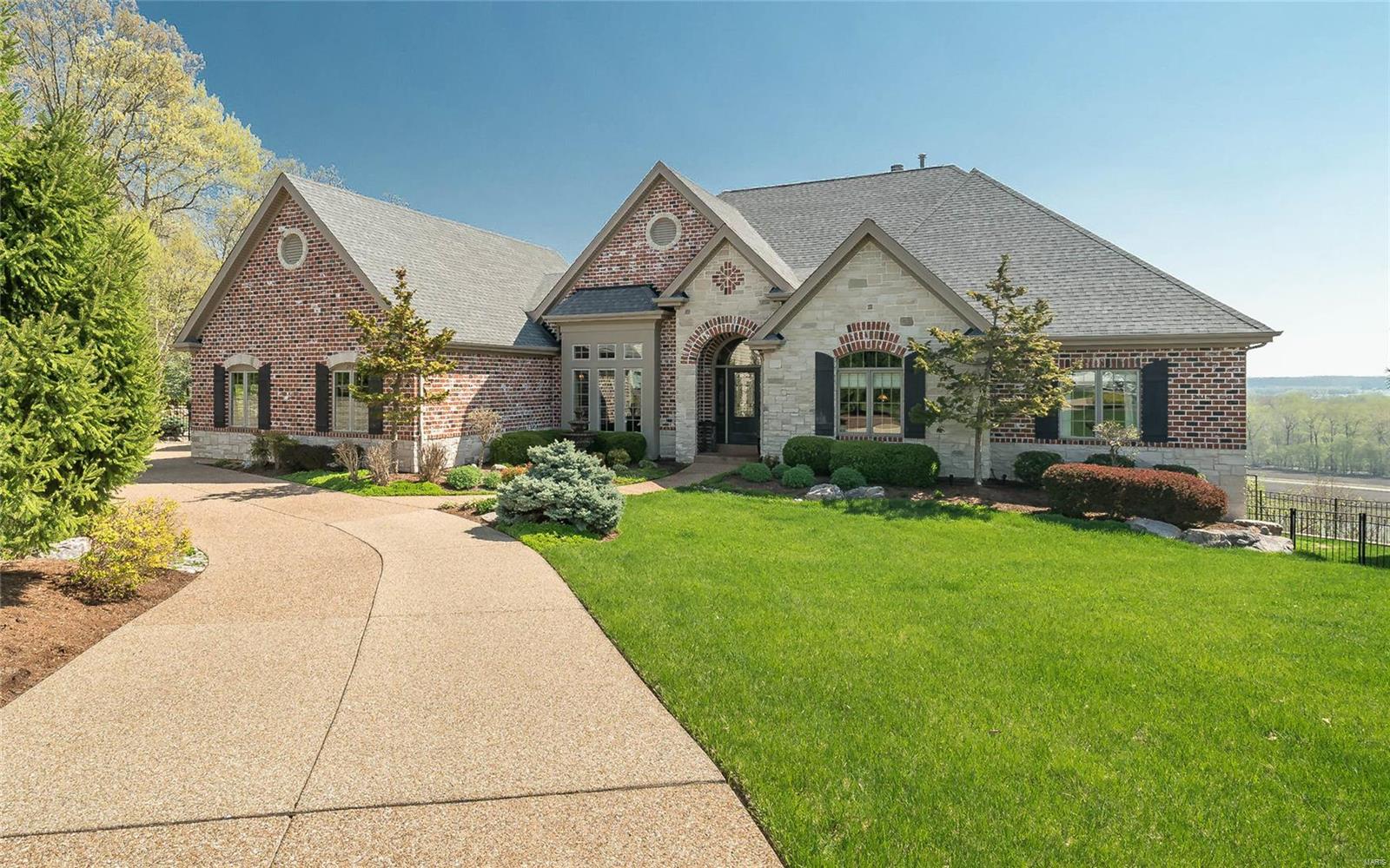 Meticulous craftsmanship & details abound in this custom 4 BDRM, 4.5 bath ranch w/ endless views of the Mississippi Bluffs. This home is nestled on a cul-de-sac embodying sprawling entertaining areas & a perfect private oasis in the backyard w/ a Hot Tub & an in-ground saltwater pool featuring a stone waterfall! As you enter, you are immediately greeted by gorgeous hand scraped hardwood floors that flow through most of the main areas. MF features a masterfully designed kitchen that is every cook's dream w/ its abundance of cabinets, two separate islands & gleaming granite counters. Gorgeous Hearth room off kitchen w/ views of backyard & bluffs! MF also has Den/Office, Formal Dining Rm, Great rm w/picture window, Mud rm, Laundry rm, powder rm, hearth rm, Master bdrm Suite, 2nd bdrm & hall bath.The stunning LL features a recreation room, bar area, wine cellar, 2 addtl. bdrms, 2 full baths & more! There is so much to this stunning one of a kind home that you just have to see to believe! Additional Rooms: Mud Room, Wine Cellar