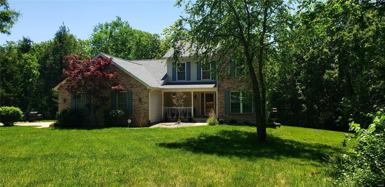 BACK ON MARKET-NO FAULT OF SELLERS! You gain $56,000+ OF RECENT UPDATES! NEW ROOF ON HOUSE & DETACHED GARAGE MAY '20, NEW SIDING & WINDOWS mid to late August & NEW 2ND FLOOR A/C!! Nestled on 4.81 WOODED ACRES this 1.5 sty 4bed/3.5bth home is a stunner. Foyer flows to formal din rm & 2 sty grt rm w/brick frplce flanked by huge windows, 2 w/motorized shades. Kit has solid surface counters, ss appliances, pantry & brkfst rm. Mn flr mst suite has huge w/i closet & lux mst bth w/adult height vanity & sep tub & shower. Mn flr continues w/pwdr rm & MN FL LAUNDRY. LL rec rm is set up to entertain a crowd & features a full bth, built-in buffet, storage rms, cedar closet, built in shelving & 2ND LAUNDRY AREA! The home has a 2 car attached ga but also offers a 2 CAR DETACHED GA w/finished room up top w/HVAC. Add'l Updts: freshly painted interior, converted loft to 4th br, ss appliances, ice line,ll fridge & trails to creek. WORTH A LOOK!