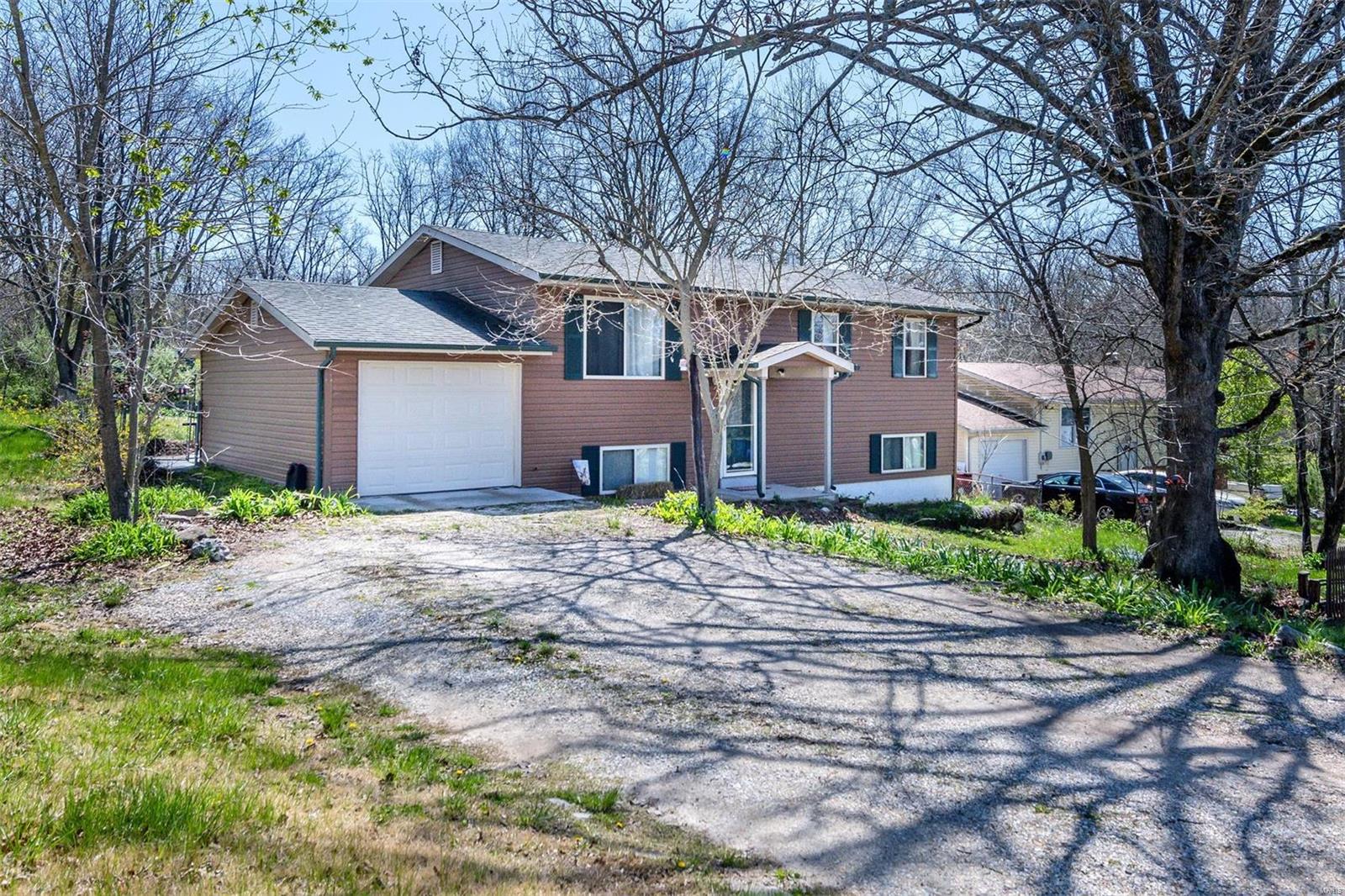 Peace and quiet in a serene lake community.  4 bedroom split foyer. The upper level features an kitchen with warm tones, granite countertops, custom knotty Alderwood cabinets, and a center island with a beautiful eucalyptus wood top! Nice covered deck off kitchen overlooking spacious fenced yard. Seller started adding a shower in master bath but unable to finish it. The lower level has another bedroom with a large walk in closet or would be ideal for a home office. Nice wood stove and dry bar area and walk out to a side patio. Large shed in the backyard for extra storage. Enjoy lake access to the three lakes in the subdivision!