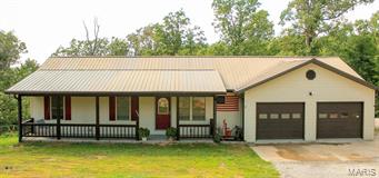 Looking for a Lake Lifestyle?  Look no further! This 3 bedroom/2 bath Ranch style home is nestled on a beautiful wooded lot in Lake Kah-Tan-Da Estates.  Take time to relax and enjoy the 3 beautiful lakes, streams, water-sports, beaches, fishing, hunting & wooded areas.  The home is nestled at the end of a lane and sits on over an acre of land.  This rustic charmer features cathedral ceilings, open floor plan, main floor laundry, back deck, and 2 car-garage.  The walk out basement features large picture windows, and French doors that open up to the spacious back yard.  Home owner has started a room addition in lower level, with your imagination and finishing touches you can easily have a large master suite, or additional family living space.  Enjoy the privacy and seclusion of this unique property, while still having access to all of the amenities & recreational possibilities.