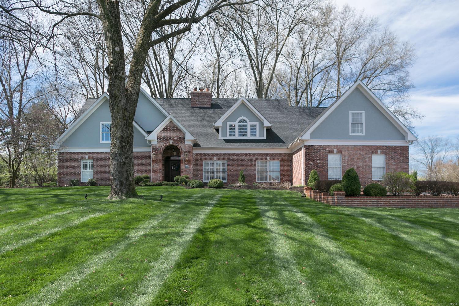 This wonderful home is best described as an open floor plan with tons of natural light. Situated on a beautiful 1 acre lot with mature trees and ample privacy, it is incredibly welcoming. The heart and soul of this home in the 2 story great room anchored by large wood burning fireplace and stacked stone surround that rises to the ceiling.  The great room is open to the gourmet kitchen with marble countertops, center island, breakfast bar, and appliances by Sub Zero, Thermador and Bosch. The large breakfast room overlooks the expansive backyard complete with water feature. The original screen porch has been converted to a beautiful sunroom off the kitchen. The main floor master bedroom suite is complete with walk in closet and updated master bath including heated floors. Upstairs are 5 bedrooms and 3 full baths plus a bonus loft space. The lower level is finished with plenty of rec space and a full bath. Oversize three car garage and main floor laundry room make this house a standout. Additional Rooms: Mud Room, Sun Room