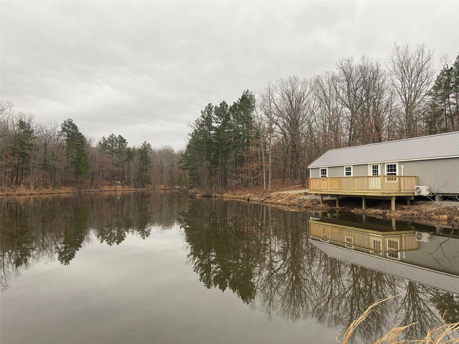 Back on market, no fault of seller. Brand new 16x48 estate cabin with deck overlooking gorgeous 1 1/4 acre stocked lake sitting in the middle of 20 acres. Property address says Salem, but property is closer to Steelville, just 15 minutes south of Steelville and is 1 1/2 hours from St. Louis. Waterfront view with furnished interior. All furniture goes to the buyer. Property can be used as a turn key vacation rental or weekend getaway. Air BNB properties in this area rent out every weekend! Home is two bedroom, 1 full bath, and has a loft. New hot water heater with hookup for washer/dryer. Brand new well & septic. All new construction. See map in last picture. Red outline is property line. Dotted blue line is a 1/2 mile cleared 4 wheeler trail. Solid blue line is lake.