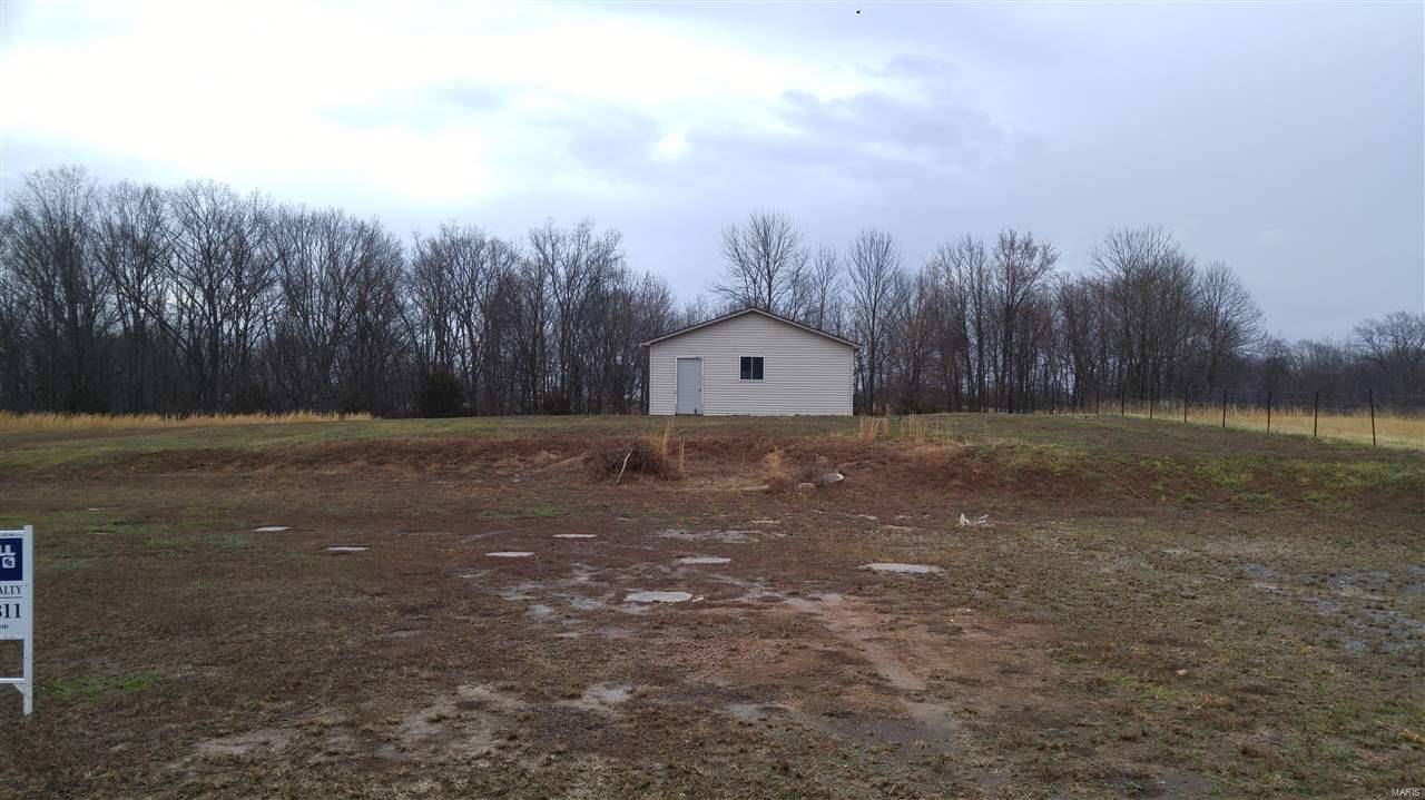 4.3 approximately acres with shop.  Approximately 2 tillable acres, water and electric. Great building spot for home,  24x30 shop has overhead doors, finished inside walls, full insulation, concrete floor and baseboard heat. Recent survey in file, $40.00 for water a month and $10.00 a month for road.