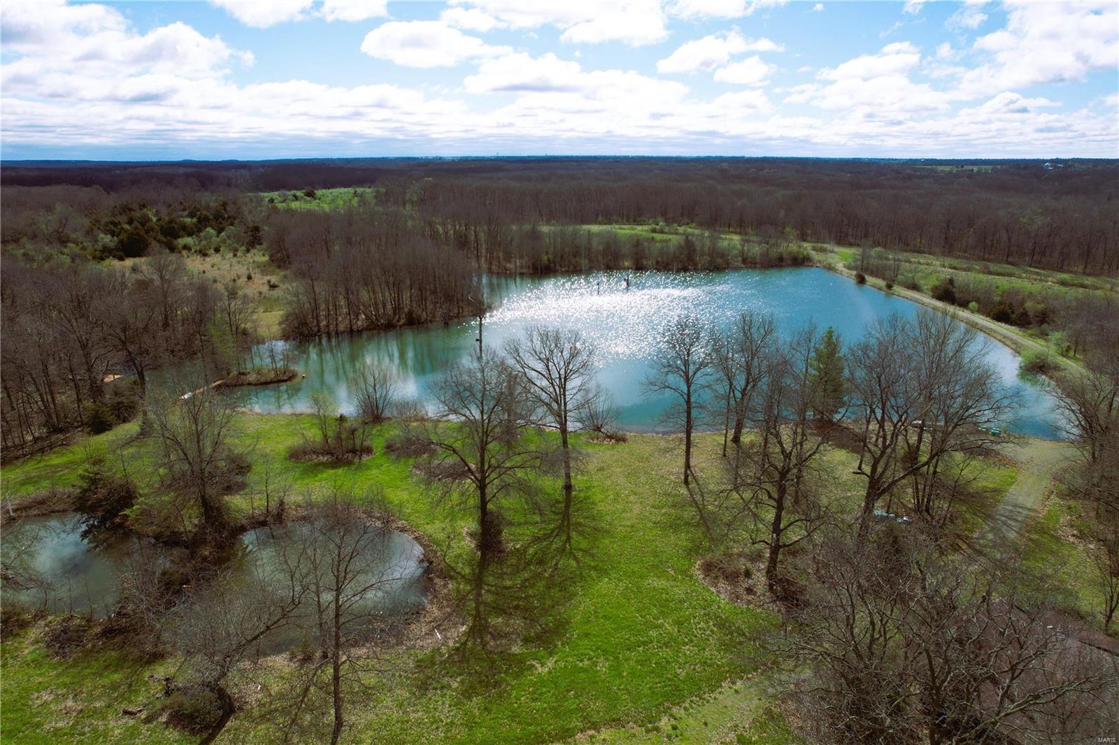 This expansive 187-acre property in Pike County, MO boasts a highly desired location and has it all! Access to the property is via a private, gated easement, ensuring ultimate privacy and security.  The property features a stunning 4.5-acre stocked lake with catfish, bass, crappie, & bluegill, as well as a 1-acre pond, both offering plenty of water for wildlife (no shortage of that here, deer everywhere!)

Extensive trail system winds through the property, perfect for hiking, SxS riding, or exploring.  A cozy 2-bedroom house on the property provides all the amenities needed for comfortable living, while a 40x60 shop with an 15-foot lean-to offers ample space for equipment storage. 

This property is truly a nature lover's paradise, with untouched beauty and potential waiting to be explored. Don't miss the opportunity to own this pristine piece of land in a PRIME location!