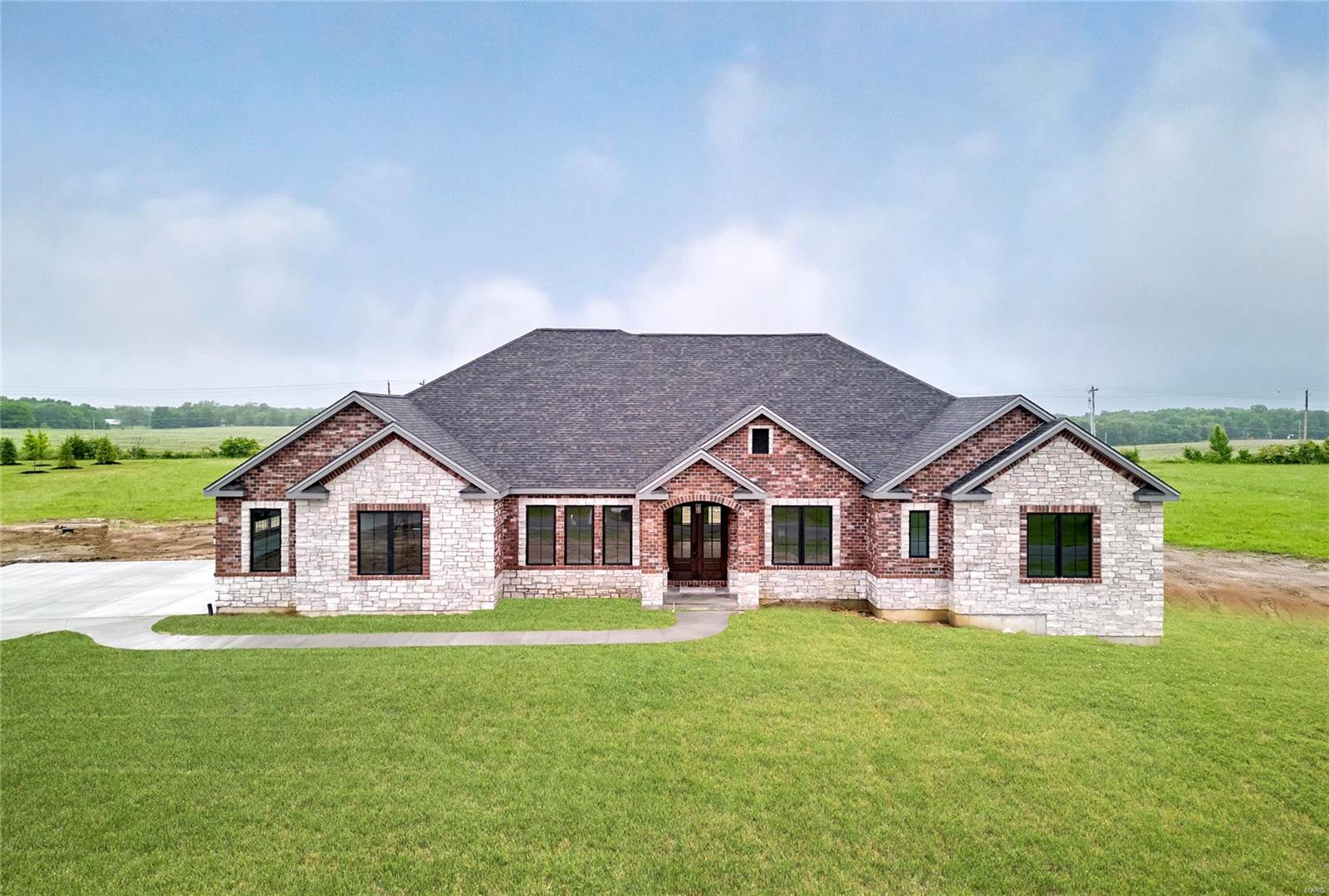 Brand new elegant custom ranch home on a 3 acre lot in Kohler Estates Subdivision just waiting for you to occupy. This home with over 5000 square feet of living space includes 5 bedrooms 3 full baths, a gourmet kitchen complete with custom cabinetry granite countertops and a complete appliance package, A large great room and hearth room each with a stone front gas fireplaces, This home has 10 and 12 foot ceilings with custom millwork, a large covered rear porch with wood ceilings, 8 foot tall interior doors, Anderson windows and much more. A large finished walk out lower level with 9 foot ceilings, a custom wet bar, another bedroom with a full bath, large rec room and separate work out or media room. Dual zone heating and cooling, tankless water heaters are included in this exquisitely constructed home. Convenient location just minutes from either Lake St. Louis or Augusta Wine Country! Additional Rooms: Mud Room