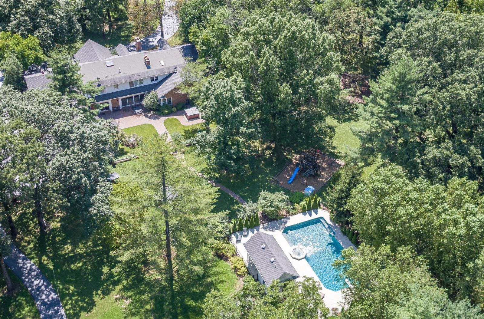 POOL HOUSE RENOVATION just finished + close to $100,000 price reduction! Subdued elegance on 3.36 acres nestled by the golf club! European classic meets Ladue privacy in this relaxed residence where superb location & extensive amenities create the perfect synergy! The home embraces modern family life on a large scale: 7500+ SQFT, 2-story foyer, graceful LR, oversized DR, beamed-wood-ceiling FR invites Nature in, custom Chef’s kitchen w/ 42” cabinets, exotic granite, SS appliances, main-floor MBR suite w/ a private office, hot tub, sauna, pebbletec-salt-water pool & pool house. Enjoy HWFL, 2 WB FPL and soothing colors, coupled w/ updated systems and 4-zoned HVAC. Finished LL, 2 guest suites on main fl., children's kingdom on 2nd fl. w/ a great room, 4 large BRs and a 2nd laundry are aided by a hallway library. Located in the heart of one of the most prestigious Ladue communities, this home provides access to top rated public & private schools, shopping, businesses & entertainment. Additional Rooms: Mud Room