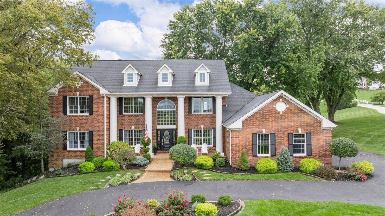 Classic, spacious 1.5 story home on an idyllic, private 1.37 acres in Chesterfield w/ sparkling, heated, saltwater pool.  Step onto the newer composite deck and imagine living here, it’s like being on vacation every day.  An entertainer’s paradise!   Just minutes from the Chesterfield Valley, while the setting makes you feel miles away.  Step inside to find 5200 + square feet w/ Brazilian wood floors plus main floor primary suite, gourmet kitchen and recently updated basement w/ concrete bar, and designer glass shelves.  Audiophiles will love the surround sound Sonos speakers in the basement and backyard. The upscale kitchen boasts Viking gas stove, Subzero fridge, a larger center island plus wet bar.  Enjoy the natural light in the great room w/ 18 foot ceilings, crown moulding and wall of windows, to take in the pristine setting.  Upstairs find 3 generous bedrooms, 1 w/en-suite, 2 more share a jack & jill and sitting room.  Highly-ranked Rockwood Schools incl.Chesterfield Elementary!