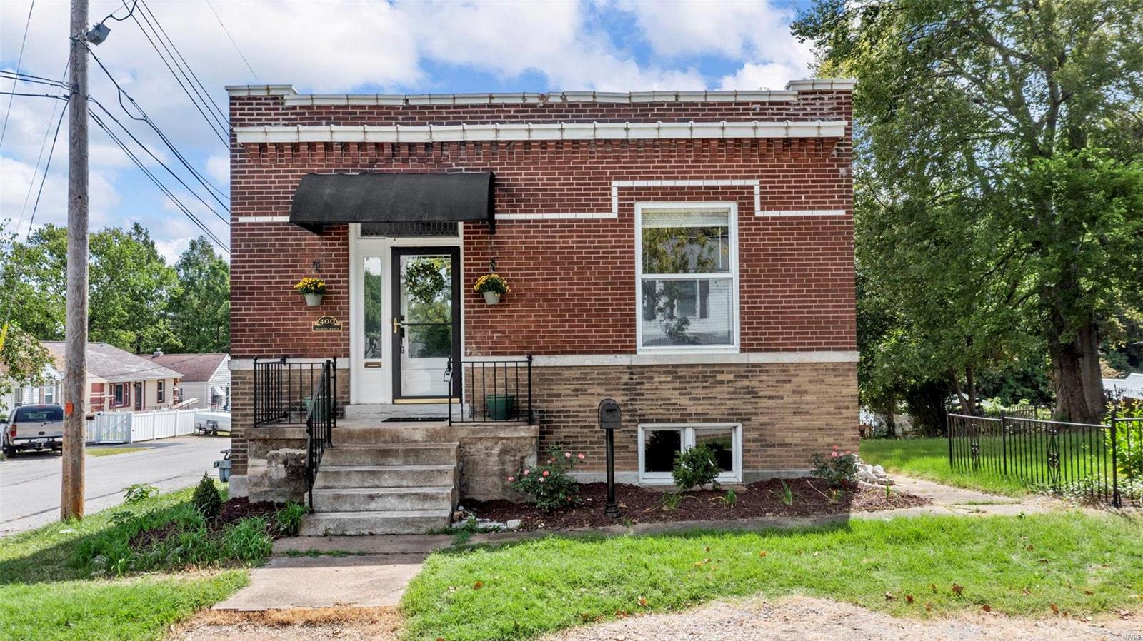 Welcome to this charming two-bedroom bungalow, ideally situated on a spacious double corner lot. Thoughtful updates have elevated its charm, including a new furnace (2021), AC (2018), fresh interior paint, and some stylish new fixtures. The home’s high ceilings, historic character, hardwood floors, and abundant natural light create a warm and inviting atmosphere that will captivate any buyer. The kitchen, featuring generous cabinet space and black appliances, is both functional and stylish. Unwind on the cozy sunporch, offering a peaceful view of the expansive, partially fenced backyard and the convenient 1-car detached garage. The dry walk-out basement offers plenty of room for storage and laundry, and is ready for your finishing touches. This home perfectly combines modern comforts with historic elegance, providing a truly delightful living experience in a sought-after location. Additional Rooms: Sun Room
