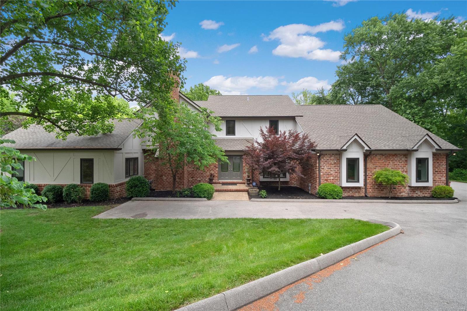 OPEN HOUSE - SUNDAY, 6/26 from 1-3 PM! Sitting on nearly a 1.5 acre lot in Frontenac & Ladue schools, this stunning, private oasis, 1.5 story home offers 5 beds, 4.5 baths, 4,181 total sq ft & a heated gunite, inground pool. The expansive entry foyer leads to a formal dining room & living room highlighted by marble gas fireplace & featuring a handcrafted wet bar. The updated kitchen utilizes every inch of storage w/ custom cabinetry & comes fully equipped w/ granite countertops, high-end appliances, center island & light-filled hearth room w/ granite fp, built-in bookcases & wall of windows overlooking pool area. Main floor primary suite w/ tray ceiling, WIC w/ custom built-ins & sep tub, offers an appealing retreat. 3 add'l bedrooms, bonus room, 2 full baths & convenient laundry complete the 2nd floor. Walk-out LL features a rec room w/ built-in entertainment center & marble wet bar, 5th bed/media room & full bath. Add'l features: HEATED DRIVEWAY, 2 decks & 3-car garage. Welcome home!