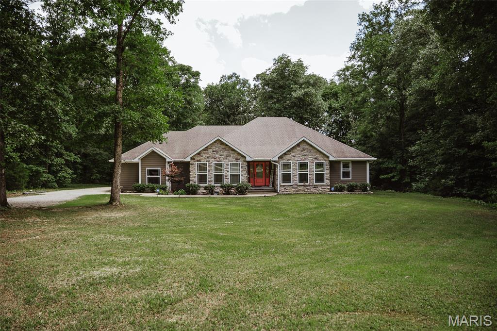 Nestled in a beautiful country setting, this spacious 4-bedroom, 3-bath home offers the perfect blend of comfort, privacy, and outdoor recreation. Bordering the Wolf Creek Trail area and Mark Twain National Forest, you'll enjoy direct access to some of the region's best hiking, hunting, and outdoor adventures. Inside, you'll find custom ceilings, three fireplaces, a bonus room, and generous living spaces designed for both everyday living and entertaining. The primary suite features walk-in closets and a private walkout patio, creating a peaceful retreat. Step outside to enjoy the partially covered deck, fenced backyard, and detached workshop with plenty of room for projects, storage, or hobbies. Properties with this combination of location, amenities, and charm are hard to find—don't miss your opportunity to make this exceptional home yours!