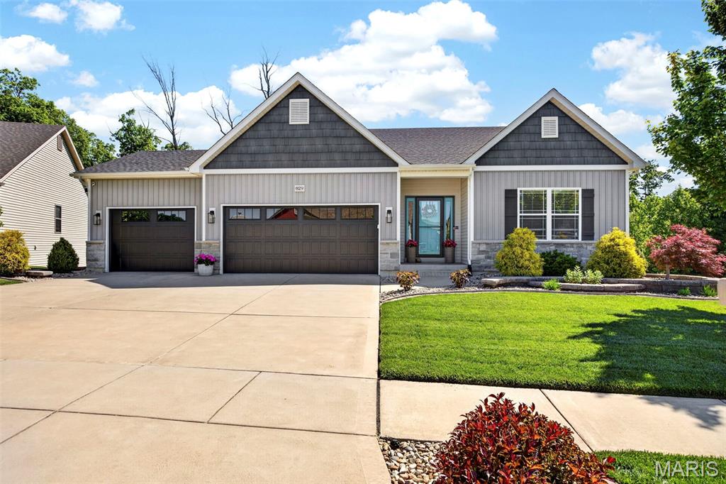 GORGEOUS GORGEOUS GORGEOUS! This home won't last! This walk out ranch has it all! Amazing curb appeal with beautiful landscaping, awesome fenced yard, great deck and amazing patio area, backs to common ground with SO MUCH privacy! As you enter, you'll find gorgeous 10' ceilings, extensive crown molding, and hardwood floors in all main areas and primary bedroom! You'll love the newly painted doors, ceilings & walls, newly upgraded front door, beautiful accent walls, recently upgraded lights, extensive window trim and finishes! The awesome open floor plan shows off the fabulous kitchen with a huge island that can fit 4 bar stools, granite counters, 42" cabinets w/upgraded handles, custom backsplash, stainless appliances incl gas stove under cabinet lighting!  Spacious dining area has transom windows and a sliding glass door that leads to the partially covered, newly stained deck w/aluminum spindles & solar lights! The great room has a custom accent wall, beautiful gas stone fireplace w/custom mantle with great natural light! The primary bedroom has beautiful custom coffered ceiling w/beams. Primary bath has a sliding barn door, tile floors, freestanding tub, separate adult height vanities, gorgeous tiled shower & walk in closet. Two addl bedrooms on main level plus full bath w/tile & transom window. The main floor laundry is updated as well with great storage. This home also offers a beautifully updated half bath for guests, which is a great upgrade!  Custom wrought iron railings at steps to lower walk out lower level. Huge family room with beautiful wet bar w/seating for 4, granite counter tops, built in ice maker, beverage cooler & LVT flooring, perfect for hosting the best parties! Huge family room w/space for your sectional and big screen TV! Recreation area offers space for your game table, plus separate office/playroom area! Bedroom 4 is great sized and 3rd full bath is beautiful w/custom shower & 1'x2' wood look tile. Tons of unfinished area w/built in storage. Step outside to a huge patio with brick paver patios on either side and extensive landscaping w/custom edging. The spacious, level backyard is fully fenced with black aluminum fencing, plus tons of space between the neighboring homes! This kind of privacy is hard to find and this home offers it all! Large hostas & truly gorgeous landscaping along the side of the house as well. Meticulously maintained! 3 car garage with beautiful updated garage doors & epoxy floor. Don't delay! Showings start Sunday 5/17 at Noon.
