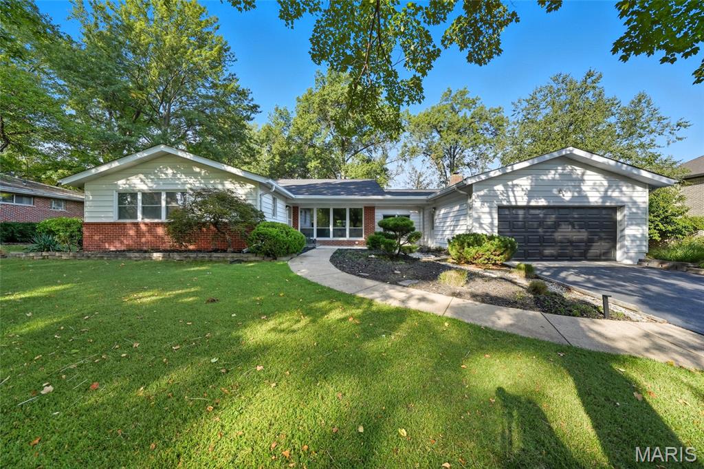 A rare chance at one of Ladue's most thoughtfully renovated ranches. Set on a level, tree-lined .55-acre lot in the coveted Ladue School District, this exceptional home offers the space, craftsmanship, and turnkey condition that discerning buyers have been searching for — and it's ready now. The quality is undeniable. The welcoming entry flows into a generous living room and formal dining area, perfectly suited for both relaxed everyday living and elevated entertaining. At the heart of the home, the dramatic oversized family room commands attention with its soaring floor-to-ceiling stone fireplace — a gathering place that never goes out of style. The custom kitchen continues to impress, anchored by a professional dual-oven range, high-end appliances, premium cabinetry, and brushed-gold hardware. A sunlit breakfast room extends the living space with peaceful views of the oversized patio and private backyard — a seamless connection between indoor comfort and outdoor entertaining. The cedar sunroom remains one of the home's most beloved features — a true four-season retreat with dedicated seating, fireplace views, and endless possibilities for lounging, reading, or hosting. The primary suite offers a genuine escape, with serene backyard views, dual closets, and a spa-inspired bath complete with tiled shower/tub, ceramic tile flooring, and dual vanity. Every additional bedroom enjoys its own fully remodeled private bath — a luxury rarely found in ranch-style living.
Downstairs, the partially finished lower level provides room to grow, with a recreation room, abundant built-in storage, and an unfinished flex space ready to become a gym, workshop, or hobby room. Main-floor laundry and dual HVAC systems round out the practical side of this exceptional property. The capital improvements speak for themselves: new roof, fully renovated bathrooms, new flooring, fresh interior and exterior paint, updated plumbing and electrical, modern lighting, and refreshed  landscaping — everything already done, nothing left to do.Moments from top-rated schools, parks, Clayton, and major highways, this is a rare opportunity to secure a fully updated home on over half an acre in one of St. Louis's most desirable corridors. The quality is here. The setting is here. Now the timing is yours.