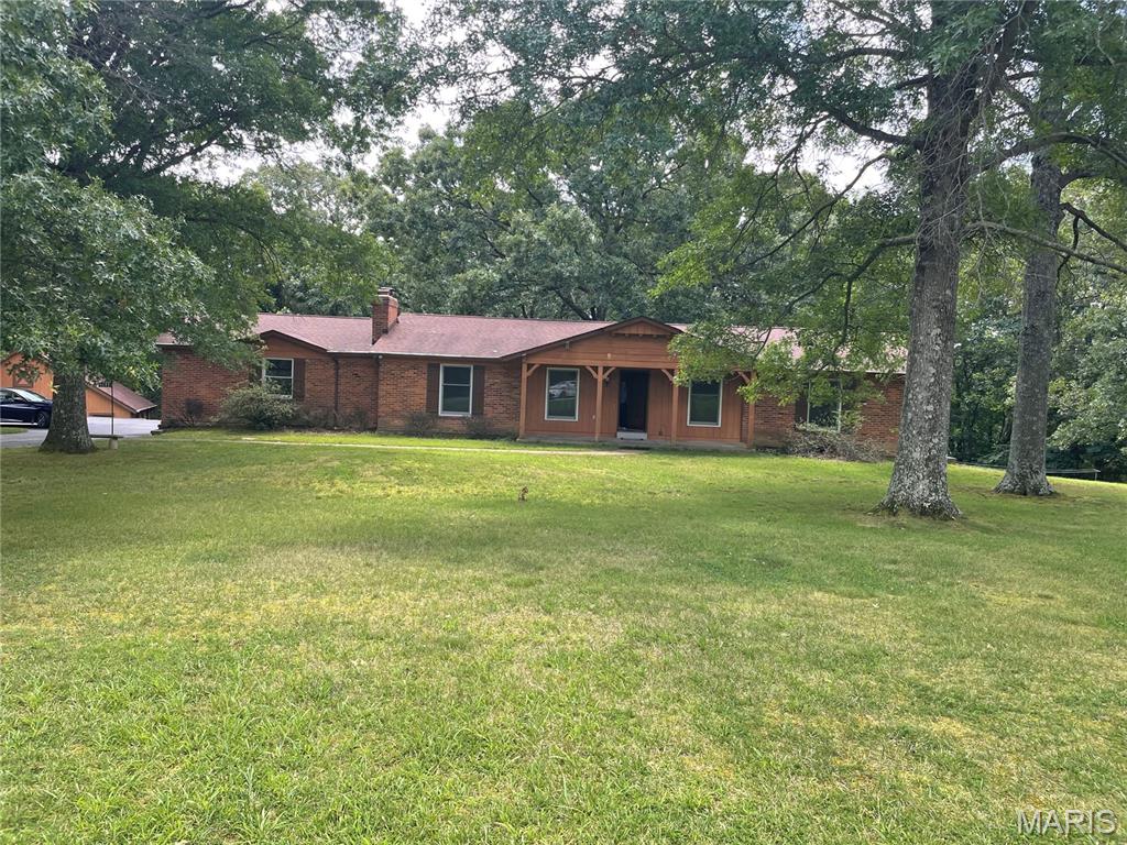 Rare opportunity in the heart of Ellisville! Tucked away off a private road at the end of a cul-de-sac, this unique 4.3-acre property is surrounded by lush, mature woods, offering exceptional privacy and breathtaking views in every season. This spacious ranch features 4 bedrooms and 4 baths, an oversized 2-car garage. Large sunroom off the back overlooks nothing but beautiful trees, creating a perfect setting to relax and enjoy nature. Home offers 2 wood-burning fireplaces. The finished walk-out lower level includes a generous-sized family room w/ fireplace, 4th bedroom, and full bath, providing an excellent space for extended family or entertaining. Outside, you'll find a 20x30 barn plus an additional storage shed, offering endless possibilities for hobbies, equipment, or workshop space. This is a true fixer-upper needing some TLC, upgrades and more, but it offers a tremendous upside. The price reflects the property's condition and outstanding improvement potential in this highly sought-after location. Professional mold remediation has recently been completed, and a clear remediation report is provided. The L.L. is missing some carpet and partial drywall as a result of the remediation, providing a clean slate for the next owner to finish to their taste. Properties offering this much acreage, privacy, and potential in the heart of Ellisville are exceptionally rare. Bring your vision and transform this hidden gem into something truly special.