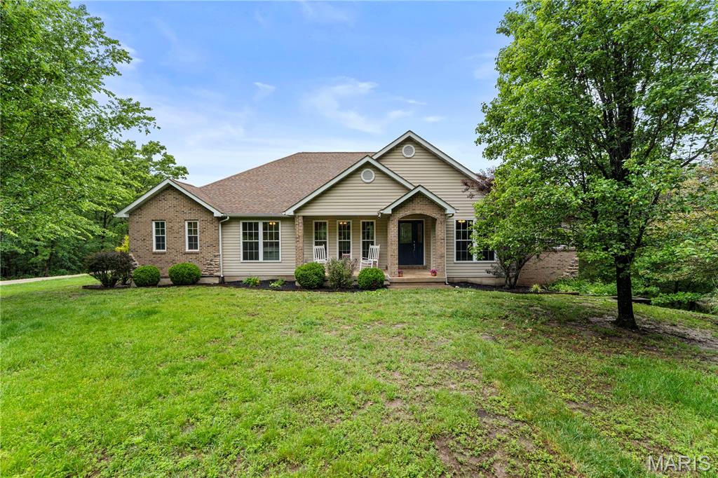 Nestled on over 5 beautiful acres, this exceptional property at 167 Wildwood Ridge offers the perfect balance of peaceful country living and convenience, located just a short drive from Washington. With 4 bedrooms and 4 bathrooms, this spacious home features soaring vaulted ceilings, rich hardwood floors, and a warm wood-burning fireplace that creates an inviting atmosphere throughout.

The private primary suite offers a relaxing retreat complete with dual vanities and a walk-in closet. Additional interior highlights include a dedicated office, main-floor laundry, and an open, functional floor plan designed for both everyday living and entertaining. Step outside to enjoy the expansive Trex deck overlooking the scenic property.

The large unfinished walk-out basement is ready for your finishing touches and already includes a full bath, offering endless potential for additional living space, recreation areas, or guest accommodations. The basement walks directly out to the private above-ground pool area, creating the perfect setup for entertaining and outdoor enjoyment.

The outdoor amenities truly set this property apart. In addition to the attached 3-car garage, there is a large detached 3-car garage offering endless possibilities for storage, hobbies, or workshop space. The acreage includes a chicken coop, garden area, and plenty of room to roam, making it ideal for those seeking a hobby farm lifestyle. Hunting is also permitted on the property, adding even more opportunity to enjoy the land and surrounding nature.

Whether you are looking for space to spread out, room for outdoor recreation, or a quiet retreat close to Washington or St. Louis, this property delivers the best of country living with modern comfort.