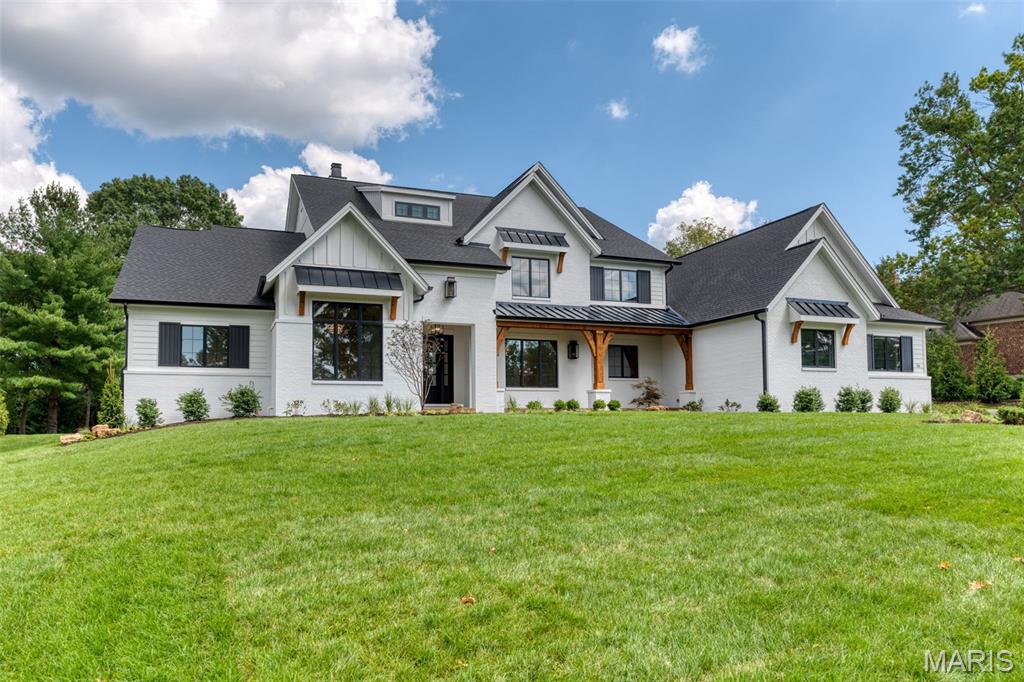 Build the Westchester IV on Manor Hill Road. A spectacular modern farmhouse estate designed to deliver exceptional luxury, architectural beauty, and effortless everyday living. Offering over 7,121 square feet of finished living space on a stunning 1.3-acre homesite, The Westchester IV blends timeless farmhouse character with refined modern design and exceptional craftsmanship.

A striking exterior showcases clean architectural lines, expansive windows, and sophisticated farmhouse detailing, creating a memorable first impression. Inside, the thoughtfully designed open-concept layout features dramatic living spaces filled with natural light, where the great room seamlessly connects to the gourmet chef’s kitchen and elegant dining areas—creating the perfect environment for both intimate gatherings and large-scale entertaining.

The heart of the home extends outdoors through an expansive covered living area, offering the ideal setting for year-round entertaining, outdoor dining, and future enhancements such as a resort-style pool, fire feature, or outdoor kitchen. A spacious four-car garage provides exceptional convenience with ample room for vehicles, storage, and recreational needs.

The private main-level owner’s retreat offers a luxurious escape with a spa-inspired bath, oversized walk-in closet, and thoughtfully designed separation from the home’s additional living spaces. The upper level includes spacious ensuite bedrooms and a versatile raised bonus room, ideal for a media lounge, playroom, secondary family room, or private retreat.

The finished lower level further elevates the lifestyle experience with expansive recreation and entertainment areas, offering flexibility for a custom wet bar, wine room, fitness studio, golf simulator, theater, guest accommodations, or other personalized amenities.

Set on a picturesque 1.3-acre homesite with room to create a truly private outdoor sanctuary, The Westchester IV is a rare opportunity to build a custom estate tailored to your vision, lifestyle, and level of luxury.

Personalize the home with your own architectural details, interior selections, and luxury finishes. Floor plans, luxury features, and customization opportunities are available upon request.

Renderings and photography may depict optional features, upgrades, and selections not included in the base offering. Pricing does not include swimming pools, outdoor specialty features, or additional site improvements.