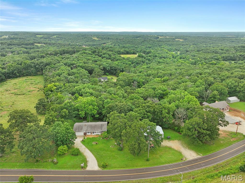 Lovely, 3bd/1.5b ranch on 3.7 acres includes a large utility garage with separate driveway. Abundant storage and cabinets in the kitchen and built-in China cabinet. Open floor plan with two family rooms, one featuring an electric fireplace which stays. Beautifully updated full bath. Master offers a half bath. The basement offers a really nice work bench area, lots of storage space and shelving, and features a wood burning stove...PLUS a storm shelter! Out in the back yard is a cute storage shed, nice landscaping and of course the large, separate garage. This home has a new water heater and HVAC. Showings begin Friday, July 10th.