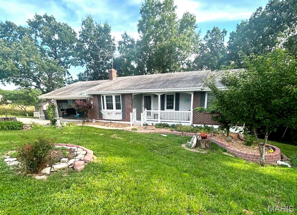 Lovely, 3bd/1.5b ranch on 3.7 acres includes a large utility garage with separate driveway. Abundant storage and cabinets in the kitchen and built-in China cabinet. Open floor plan with two family rooms, one featuring an electric fireplace which stays. Beautifully updated full bath. Master offers a half bath. The basement offers a really nice work bench area, lots of storage space and shelving, and features a wood burning stove...PLUS a storm shelter! Out in the back yard is a cute storage shed, nice landscaping and of course the large, separate garage. This home has a new water heater and HVAC. Showings begin Friday, July 10th.