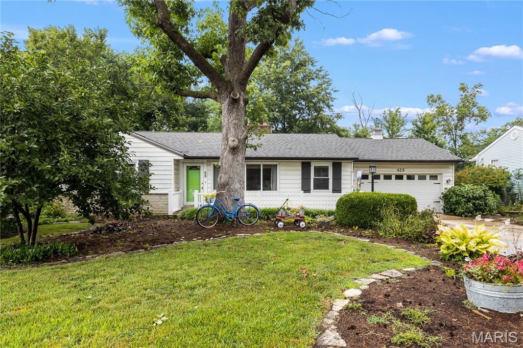 Warm and welcoming is this home! There is plenty of flora and attractive plants throughout the front and back yards. This is a beautifully maintained home on a nice quiet and serene lane in South Webster. Enter into a large living room with a picture window overlooking the front lawn and a wood burning fireplace! Three bedrooms on the main level and a full bath. The center bedroom could be an office or maybe a nursery. The lower level is very cozy and comfortable. There is another fireplace there and a large picture window viewing the back yard. There is also a workbench area for the hobby enthusiasts. The yard is spectacular!  It's private and full of perennials and colorful birdhouses!