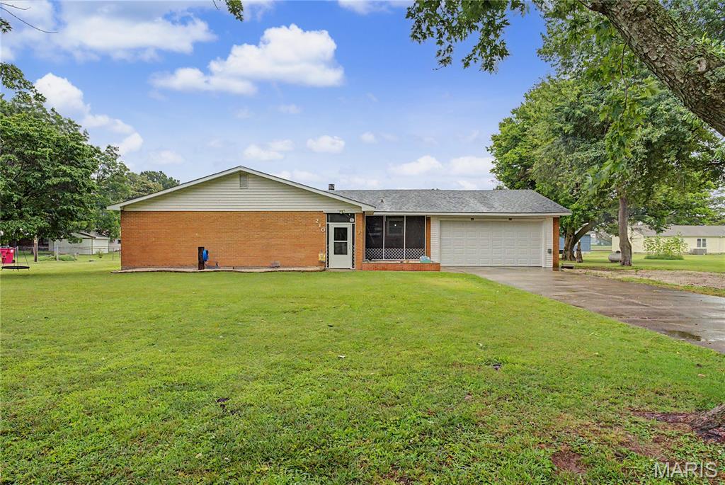 Welcome home to 210 Sherrie Drive! This beautifully remodeled ranch home offers 2,121 square feet of thoughtfully designed single-level living space. Step inside to find durable, modern luxury vinyl plank (LVP) flooring running seamlessly throughout. The heart of the home features a spacious, inviting living room anchored by a cozy wood-burning fireplace—perfect for crisp evenings.

The true showstopper is the massive primary suite, boasting an oversized walk-in closet and a luxury spa-like bathroom. You'll love the architectural glass wall separating the custom walk-in shower from the bedroom, alongside a separate, deep soaking tub for ultimate relaxation. Convenience is built-in with a dedicated laundry room situated right off the garage entrance to catch daily clutter. Outside, the sprawling 0.46-acre flat yard provides an incredible blank canvas with tons of room for kids, pets, or weekend entertaining. Don't miss this turnkey Sikeston gem!