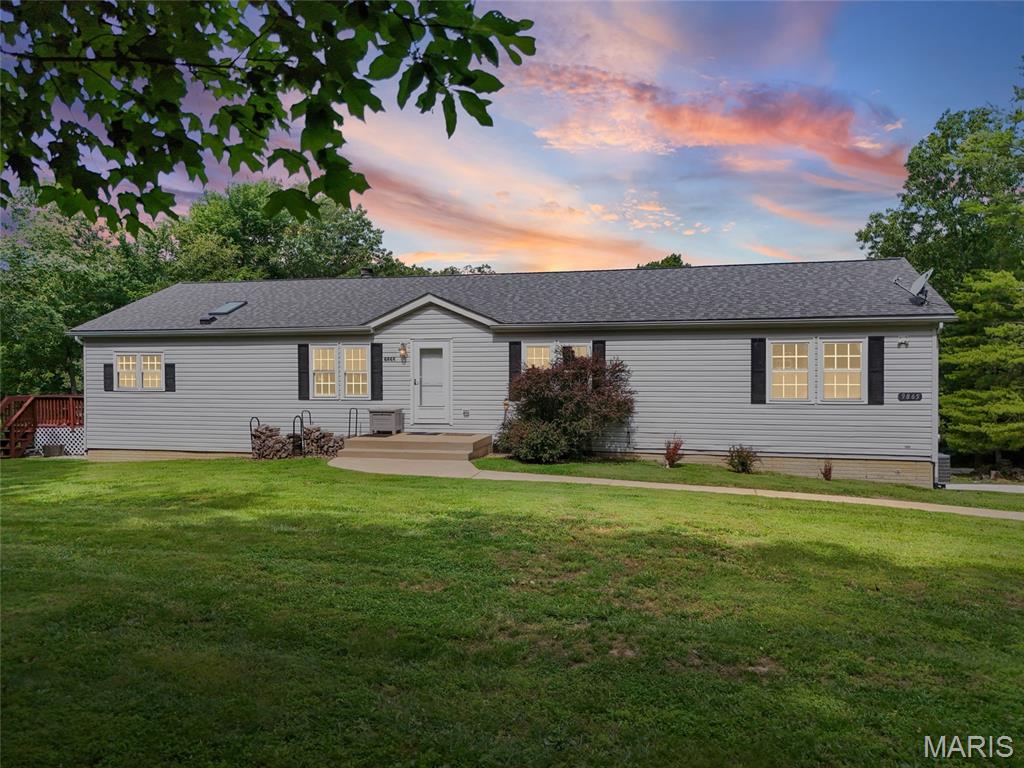 Back on market, no fault of sellers! First time on the market and nestled on nearly 5 unrestricted acres in the Hillsboro School District, this beautifully updated 3-bedroom, 2-bath home offers the perfect blend of privacy, comfort, and functionality. Enjoy peaceful country living with frequent deer and turkey sightings, all while still being conveniently located near town. Step inside to an inviting open floor plan featuring luxury vinyl flooring throughout the main living areas, a cozy wood-burning fireplace in the great room, and a charming sitting area with built-in shelving. The updated kitchen is sure to impress with refinished cabinetry, center island, new countertops, stylish backsplash, and all appliances included — even the washer and dryer. Glass doors lead to a spacious 16x20 deck, perfect for entertaining, grilling, or simply relaxing while taking in the private wooded setting. The primary suite offers a large walk-in closet and spa-like bath with a new shower enclosure and oversized soaking tub. Main floor laundry, fresh paint throughout, an updated guest bath, and numerous improvements make this home truly move-in ready. The finished walk-out lower level provides even more living space with a large recreation area, sleeping area, bonus room, professional-grade treadmill, and ample storage. The full walk-out basement also includes a 2-car tuck-under garage. Additional updates include HVAC, water heater, water softener, windows, interior doors, and baseboards. Outside, you’ll find a 12x16 lofted outbuilding plus plenty of room to add a pole barn, detached garage, garden, or additional outbuildings. Unrestricted acreage, modern updates, privacy, wildlife, and room to grow — this is a rare opportunity. Must see inside to appreciate all this wonderful property has to offer!