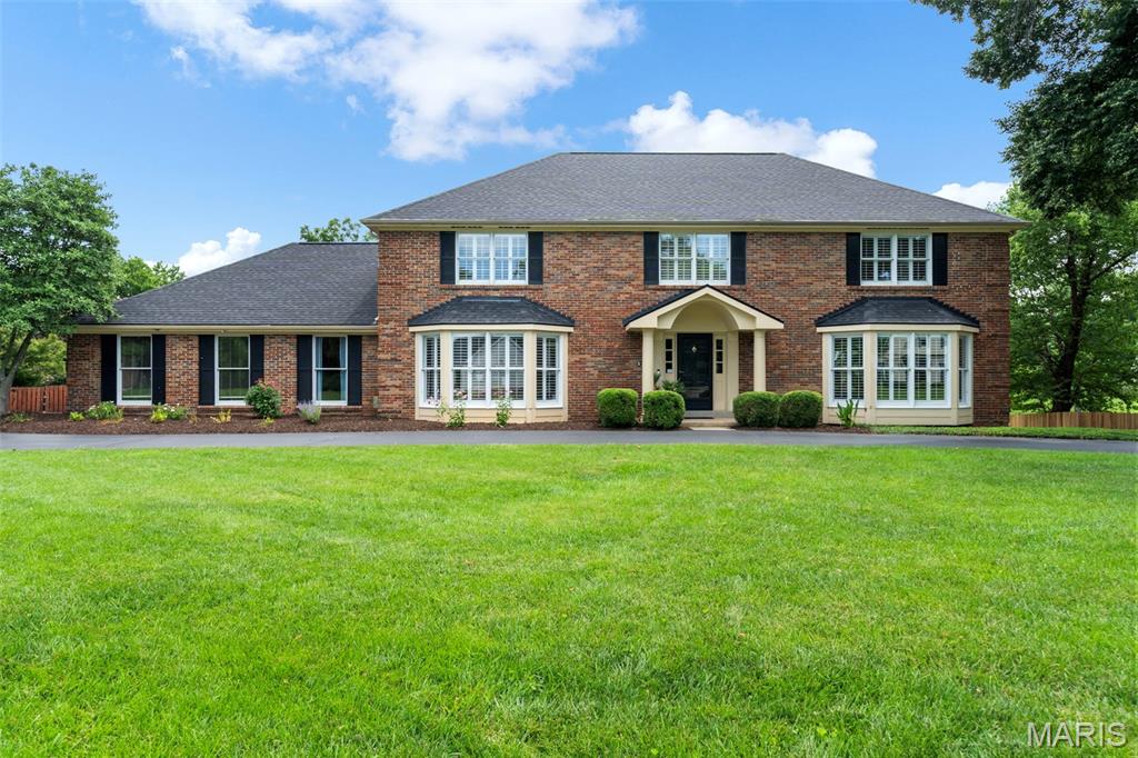 Open House Sunday 7/12, 1-3.  Set on a beautifully landscaped 1.02-acre homesite with private lake access in the prestigious Chesterfield Meadow community, this distinguished all-brick estate offers a rare combination of timeless architecture, refined comfort, and resort-style living within the Rockwood School District.  A sweeping circular drive creates a grand first impression, complemented by a side-entry garage and expansive parking designed to accommodate both everyday living and elegant entertaining. Inside, the home unfolds with generously scaled living spaces, a sophisticated neutral palette, and sunlit bay windows that bathe the interiors in natural light.  The thoughtfully designed floor plan blends form and function, featuring a private main-floor guest suite, an adaptable formal living space ideal for a refined home office or sitting room, cheerful eat-in kitchen with granite counters and a well-appointed main-floor laundry. The updated primary suite offers a serene retreat, while spacious secondary bedrooms upstairs provide comfort and privacy for family and guests.  Outdoor living is truly exceptional. A screened-in porch overlooks the tranquil lake and lush grounds, while the saltwater pool creates a resort-like setting perfect for both quiet relaxation and elevated entertaining. The finished walk-out lower level, complete with a full bath and dressing area, offers seamless access to the pool and grounds—ideal for hosting or extended stays.  Designed to accommodate both intimate moments and grand gatherings, this residence delivers an unparalleled lifestyle in one of Chesterfield’s most desirable settings.