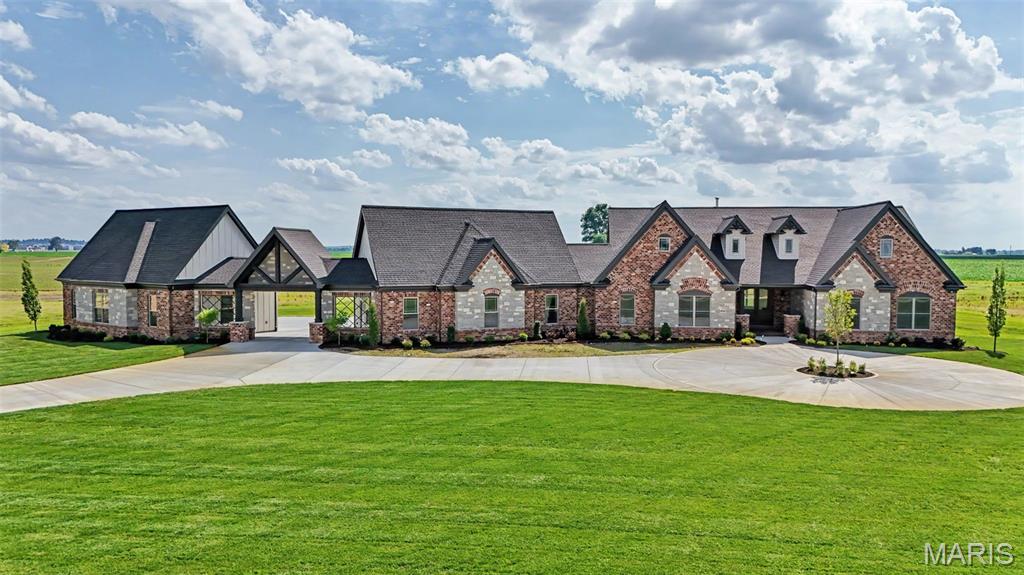 Experience Luxury living on 5 acres in this new custom built home, by TR Hughes Homes which is now completed.  Blending classic architectural design with a striking stone & brick exterior, James Hardie siding, cedar accents, and Andersen windows. A circle drive leads to two separate 4 car garages with 8' tall garage doors, finished painted walls, concrete floor coating & a Porte Cochere connecting them, which any car enthusiast would love.  This home has a beautiful 8' tall arched glass double front door, 11' ceilings in the main living areas, an oversized fireplace with stone to the ceiling & stunning floors. The custom Kitchen is a chefs dream with designer finishes, including a large island with lots of seating, GE Cafe appliances including cooktop with cabinetry hood and double oven, Kohler sinks, pot filler, Quartz countertops & a Herringbone tiled backsplash. The large walk-in butlers pantry has built-in cabinetry with Cambria countertops, making for the perfect location for a coffee bar. The laundry room also includes built-in cabinetry, Cambria countertops and a laundry sink. Off of the Dining room, there is plenty of room to entertain under the grand 20' x 20' vaulted covered stamped concrete patio.  The Primary suite has a tray ceiling with crown molding & lighting, 2 separate walk-in closets with custom shelving, a luxury bath with a freestanding tub, separate tiled shower with seat, dual vanities, a private water closet, Cambria countertops & a linen closet.  There is an additional bedroom suite with it's own private bath & walk-in closet.  The other 2 bedrooms each have their own walk-in closet.  This home is also equipped with a security system that includes cameras and a technology package. Additional highlights include 12" x 24" tiled floors in all 4 bathrooms & laundry room, GAF HDZ Shingles, 8' tall doors, matte black levers, iron spindles, 5 1/4" painted wood door casing, 7 1/4" painted baseboards, a 22 kw whole home gas generator on a concrete pad, Irrigation system, ( 2 ) 50 gallon hot water heaters & so much more!  As a bonus, there is a vault room as well.  A total of 12 homesites at Twin Silos with only 7, five acre lots remaining.