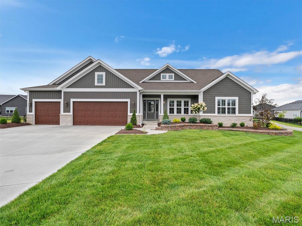 Experience elevated living in this exceptional 3-bedroom, 2.5-bath luxury residence, gracefully situated on a quiet cul-de-sac in the highly sought-after Inverness subdivision. Showcasing thoughtfully curated designer finishes and impeccable craftsmanship, this home offers the perfect balance of sophistication, comfort, and modern convenience. The gourmet chef's kitchen is a true centerpiece, featuring elegant quartz countertops, premium Cafe stainless steel appliances, a double wall oven with built-in microwave, a professional-grade gas cooktop, and a beautifully appointed butler's pantry with coordinating designer tile that seamlessly extends the home's refined aesthetic.  Wide-plank engineered hardwood flooring flows throughout the main living spaces, leading to a stunning great room anchored by a custom gas fireplace with built-in cabinetry and an impressive 72-inch walnut propeller-style ceiling fan. Integrated smart home technology provides effortless control of climate and security. The private owner's retreat is a luxurious sanctuary, enhanced by a breathtaking statement chandelier and a spa-inspired ensuite featuring an expansive designer tile shower, dual quartz vanities, and premium finishes. A beautifully appointed Jack-and-Jill bath showcases distinctive Italian live-edge tile, while plantation shutters and motorized blinds add timeless elegance throughout. Exceptional attention to detail continues with a custom-designed mudroom, oversized water heater, and a finished garage featuring professionally installed polyaspartic flooring and premium jackshaft garage door openers. Designed for effortless indoor-outdoor living, the professionally landscaped grounds include a sophisticated seven-zone irrigation system, a freshly landscaped backyard framed by 32–34 newly planted Southern Magnolia trees along the rear property line, creating a stunning natural backdrop and future privacy screen. The screened-in porch, complete with a luxurious Caldera Spa, offers the perfect retreat for year-round relaxation. Ideally located within the award-winning Wentzville School District and just minutes from premier shopping, dining, parks, and recreation, this extraordinary residence offers an exceptional lifestyle where luxury, comfort, and timeless design come together seamlessly.