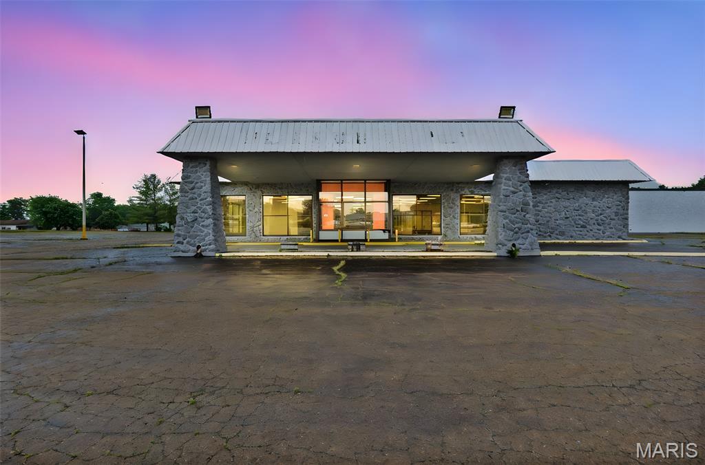 Prime commercial opportunity in Ste. Genevieve, MO! This former Ford dealership is strategically located on a hard corner at a signalized intersection along one of the city’s busiest corridors. The property features approximately 26,000 square feet of versatile building space, thoughtfully divided into a spacious showroom, service bays, parts department, and autobody shop, and offering endless potential for reuse or redevelopment and +42k weekly traffic counts.
Main parcel spans 2.52 acres, providing ample parking and vehicle storage, with an additional 0.92-acre lot adjacent to the property available for purchase separately. With multiple curb cuts and high traffic visibility, this site is well-positioned for a range of commercial uses, from automotive, ag and RV sales, industrial services, retail conversion, to a full mixed-use redevelopment project.
Originally constructed as a bowling alley before becoming a longtime Ford dealership, the structure reflects solid bones and adaptable space ready for its next chapter, including new flat roof. Take advantage of this high-exposure, high-traffic location with new 157 unit residential subdivision starting within .5 mile.  Whether you're an investor, business owner, or developer, this property offers a rare combination of size, access, and opportunity.