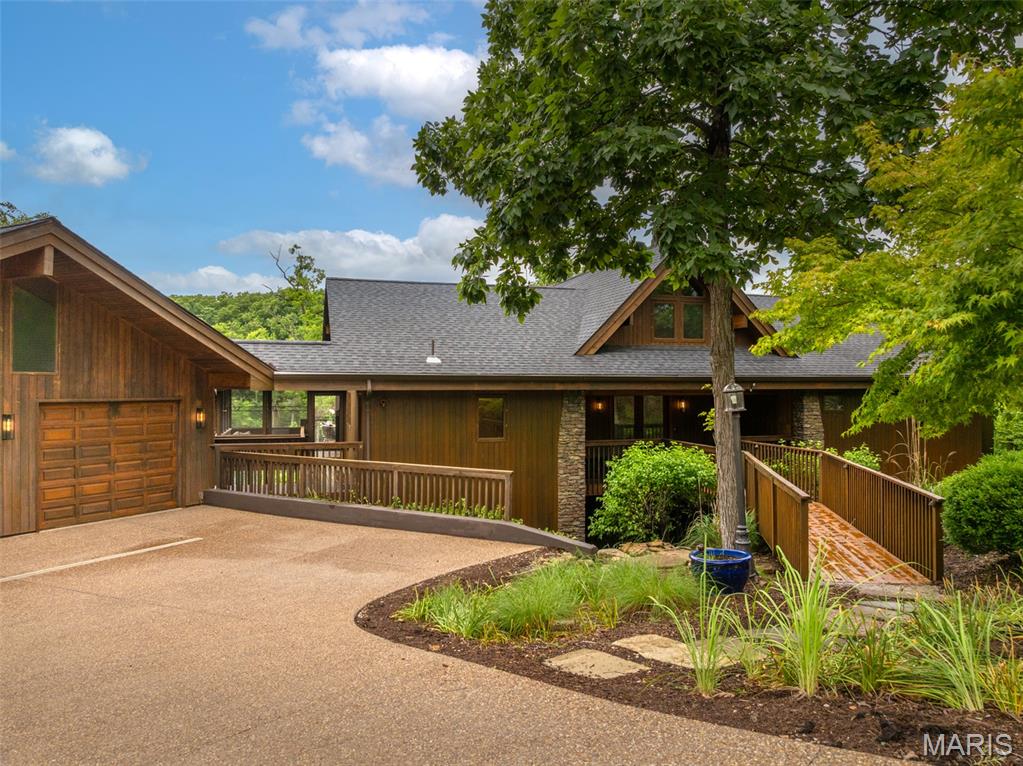 Nestled along the shimmering shores of Alpine Lake, this exceptional waterfront retreat offers refined lake living at its finest. Spanning over 3,400 square feet, the home features 4 bedrooms and 3 baths with a bright, open floorplan designed to capture stunning water views from nearly every room. Rich hardwood floors anchor the main level, while oversized windows flood the space with natural light. The showpiece of the home is the breathtaking two-story wraparound deck—perfect for entertaining or quiet moments overlooking the lake—complemented by a screened-in porch for year-round enjoyment. Outdoors, unwind by the fire pit, launch a kayak from your private dock, or simply soak in the serene setting. A fully finished lower level adds flexible living space, and an attached garage offers everyday convenience. This is luxury Innsbrook living—where every detail invites you to relax, recharge, and make lasting memories on the water.