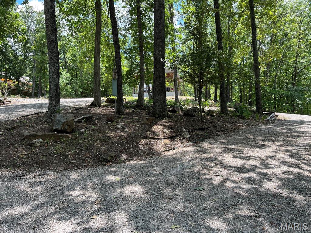 Lake days are here and this build or permanent camp lot is located in the gated community of lake perry. This lot features water, sewer, and electric and a deck that allows you to have water views year round. As a bonus the camper on the lot stays as well as the utility shed truly making this lot turn key.