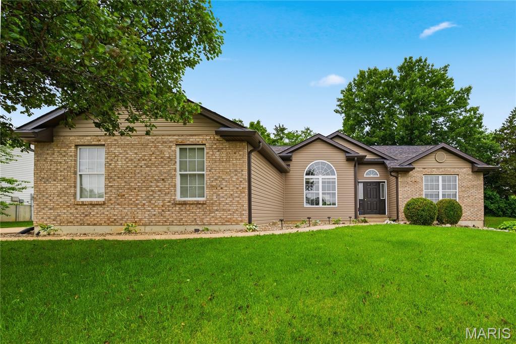 This split ranch offers the perfect blend of space, style, and functionality! Step inside to a vaulted great room, kitchen and dining room that creates an open, airy feel and flows nicely into the separate dining room and kitchen featuring 42-inch cabinets, stainless steel appliances, and plenty of space to gather. The spacious primary suite has a vaulted ceiling, large walk-in closet, double bowl vanity, separate tub, and shower. Main-floor laundry adds everyday convenience, while the side-entry garage enhances the curb appeal. Jack and Jill bathroom connects bedroom 2 & 3.  Sitting on a large corner lot that backs to a peaceful wood line, this home offers the privacy and setting buyers love. The finished lower level expands your living space with a large family room/rec room, two sleeping areas—one with a walk-in closet—and a full bath. This one has room for everyone and so much to love!