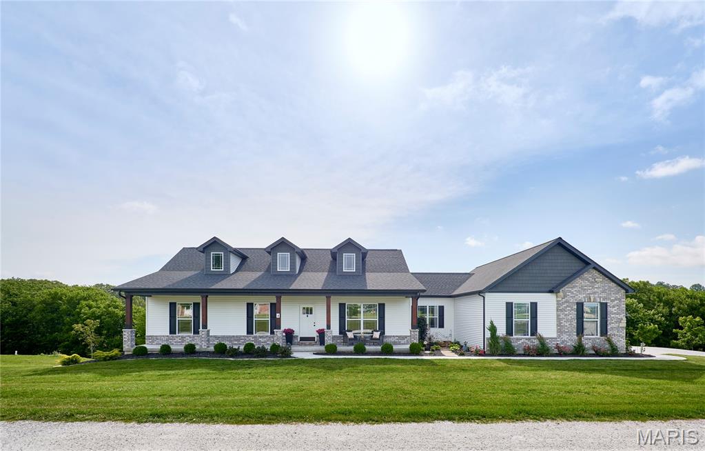 Why wait to build? This nearly new home on 2 private acres offers modern finishes, thoughtful upgrades, and room to grow. The open-concept floor plan is filled with natural light and features a beautifully appointed kitchen with quartz countertops, a large center island, 42" shaker-style cabinets with crown molding, soft-close doors and drawers, black stainless appliances, and an oversized walk-in pantry. Refrigerator, washer, and dryer are included. Step outside onto the Wolf composite deck and enjoy peaceful views of the surrounding countryside. The professionally landscaped lot also features an expanded patio with fire pit, creating the perfect setting for relaxing or entertaining. The spacious primary suite offers a walk-in closet and a luxurious bath with a custom marble walk-in shower, rain head, and transom window. Two additional bedrooms, a full bath, dedicated laundry room, and a fantastic mudroom with built-in storage complete the main level. The walkout lower level is ready for your vision with three egress windows, rough-in plumbing for a future bath, a large concrete safe room, and ample space for additional living areas. A rare bonus: approved detached outbuildings and workshops are allowed, giving you the flexibility to add extra garage space, storage, or the workshop you've always wanted. Additional features include luxury vinyl plank flooring, custom trim and doors, Hunter Douglas blinds, window tinting, a high-end water softener, and an oversized insulated and drywalled 3-car garage. Motivated seller — a wonderful opportunity to enjoy the benefits of new construction without the wait!