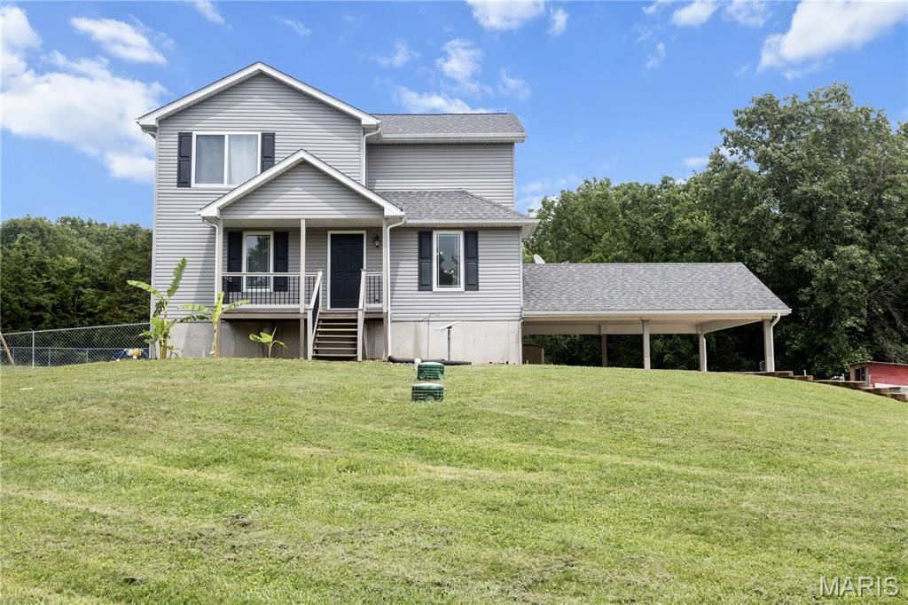 Welcome to this beautifully remodeled 4-bedroom, 2-bath, 1.5-story home nestled on a sprawling 2.54-acre lot with no restrictions—offering the perfect blend of modern comfort and country freedom. Thoughtfully rebuilt from top to bottom in 2019, this home combines contemporary finishes with timeless charm, creating a space that’s ready for any family to enjoy. 
Step inside and you’ll immediately appreciate the open-concept floor plan designed for effortless living and entertaining. The great room flows seamlessly into the formal dining area and a beautiful kitchen, featuring maple cabinetry, granite countertops, stainless steel appliances, and a large walk-in pantry for exceptional storage. Every detail has been carefully considered to balance style and functionality. 
The primary suite is conveniently located on the main level, complete with a full bath and dual closets, offering privacy and convenience. Upstairs, you’ll find three spacious bedrooms, each with walk-in closets, and a full bath with double sinks—ideal for family or guests. The home also features dual HVAC systems, one for each level, ensuring year-round comfort and efficiency. 
The lower level offers additional potential with a rough-in bath, walkout access, and an oversized one-car garage that connects to a two-car carport—providing ample parking and workspace options. Outdoor living is equally inviting: a fenced area off the deck opens to a large, level yard, perfect for play, gardening, or gatherings. A charming chicken coop and small fenced area for roaming add a touch of country character to this versatile property. 
With its generous acreage, modern updates, and flexible layout, this home delivers the best of both worlds—peaceful rural living with all the conveniences of a contemporary remodel. It’s truly a place where comfort, space, and freedom come together beautifully.