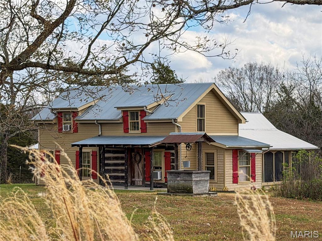 Look no further- your dream farm has arrived. This remarkable 141.7-acre historic property offers all the charm and curb appeal you could ask for. the original farmhouse built in 1840 with additions completed through 1927, has been thoughtfully updated while preserving its timeless character. Offering 2 bedrooms, 2 baths, And just under 1800 ft.², this home blends history and comfort beautifully.
From the inviting front porch showcasing exposed historic logs to the warm living room, where the original cabin walls remain on display, the home, radiates, rustic charm. Barnwood accents, wood floors throughout most of the home, and a loft overlooking the great room, all create a truly unique and welcoming atmosphere. Every window frames a magical view of the surrounding countryside. 
Recent updates have enhance the homes functionality without sacrificing its farmhouse feel- including an expanded laundry and bath on the east side and a serene screened porch on the west side perfect for morning coffee or evening sunsets the view of the 50 x 60 barn from the porch is simply breathtaking.
The land features seven mostly fenced pastures with wooded areas and two spring-fed, creeks that run year-round ideal for cattle and other livestock. additional improvements include a cellar, a 23 x 26 detached garage freshly painted and a 42 x 50 shed with a lien and concrete floor, enclosed room. a large windmill near the barn and shed adds even more classic country charm. There’s also a small pond in the back pasture and attractive wooden fence along the road frontage
The owner had completed numerous thoughtful updates over the years, including new flooring, insulation upgrades, concrete slabs, and Joyce replacement, restored original woodwork, bathroom upgrades, and a professional installed metal roof with spray foam insulation. Newer septic system as additional piece of mind. This is a rare opportunity to own a beautiful preserved historic farmhouse on an exceptional piece of land country living at its finest.