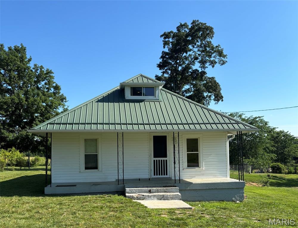 Mini-homesteading at its best! This charming 2-bedroom bungalow on 3.40 acres is ready for aspiring homesteaders, with a grape arbor, blackberries, barley, vegetable garden, and chicken pen already in place. Enjoy peaceful outdoor living, serene views, and gorgeous sunsets from this lovely setting. The home is well cared for and includes a bonus room that could serve as a possible third bedroom, plus a partial basement for storage or storm shelter use. For those seeking small-scale country living, this is a wonderful opportunity!