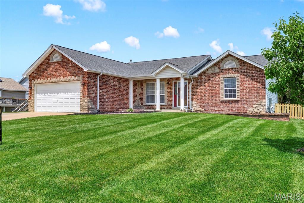 Some homes are updated. This ranch is one-of-a-kind! The open main level features vaulted ceilings, a cozy wood-burning fireplace, and an updated kitchen with quartz countertops, custom cabinetry, smart under-cabinet lighting, and stainless steel appliances that stay with the home. Downstairs, the finished walk-out lower level is a standout, offering a second kitchen with quartz countertops, a spacious living area, bedroom, bath, and bonus room perfect for multi-generational living, long-term guests, or the ultimate entertainment space. The backyard is every bit as impressive as the interior, featuring a peaceful waterfall, landscape lighting, and a full irrigation system that keeps everything looking its best with minimal effort. Major updates include a new roof (2026), new electrical panel (2025), new water heater (2025), EV charger, smart home features, and whole-home audio wiring. Every improvement reflects pride of ownership and attention to detail. This isn't just move-in ready. It's a home that's been thoughtfully upgraded for the way you live today.